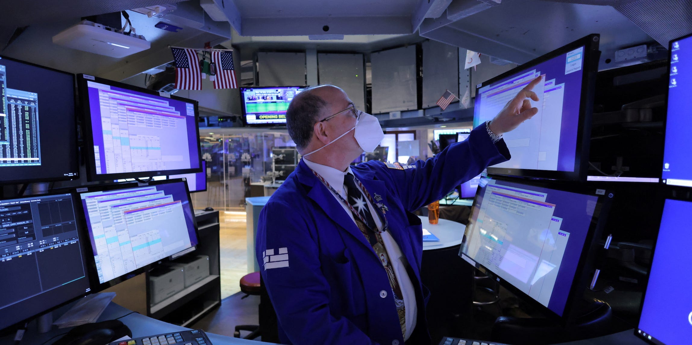 Trader points at screen at NYSE