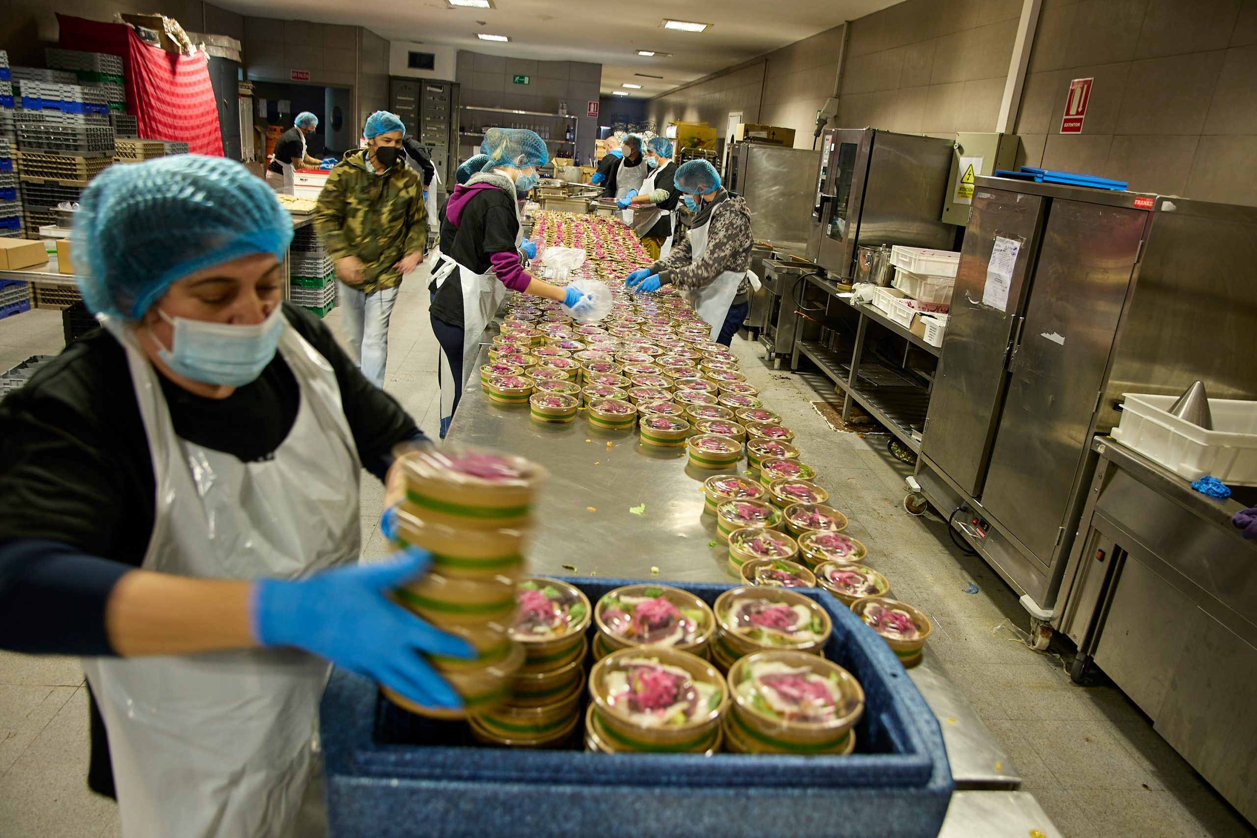 Chefs and volunteers prepare a menu and Christmas hampers, on 19 December, 2021 in Madrid, Spain.