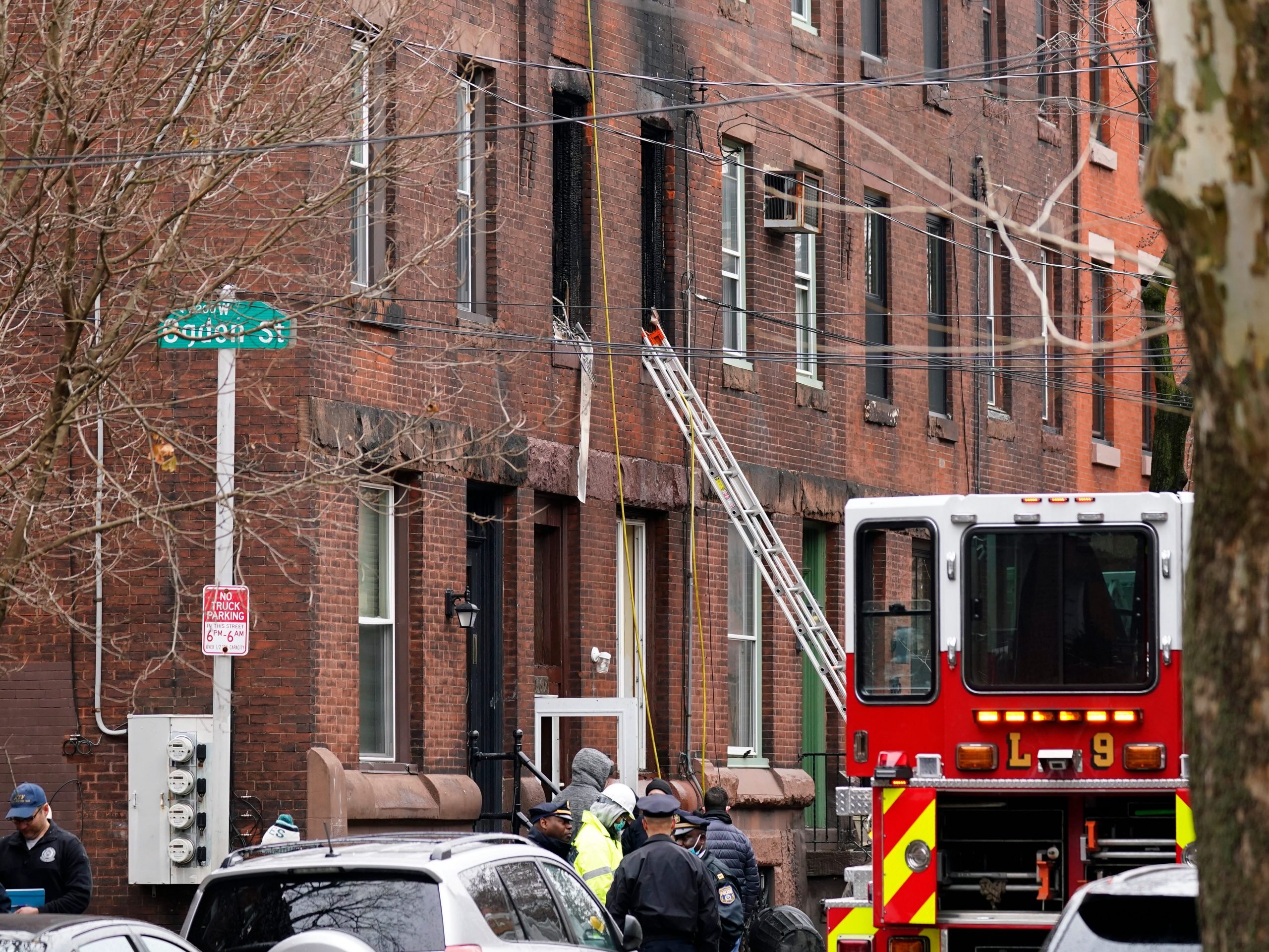 Philadelphia firefighters and police work at the scene of a deadly row house fire, Wednesday, Jan. 5, 202