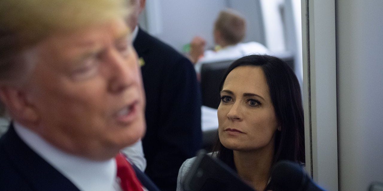 White House Press Secretary Stephanie Grisham listens as US President Donald Trump speaks to the media aboard Air Force One while flying between El Paso, Texas and Joint Base Andrews in Maryland, August 7, 2019.