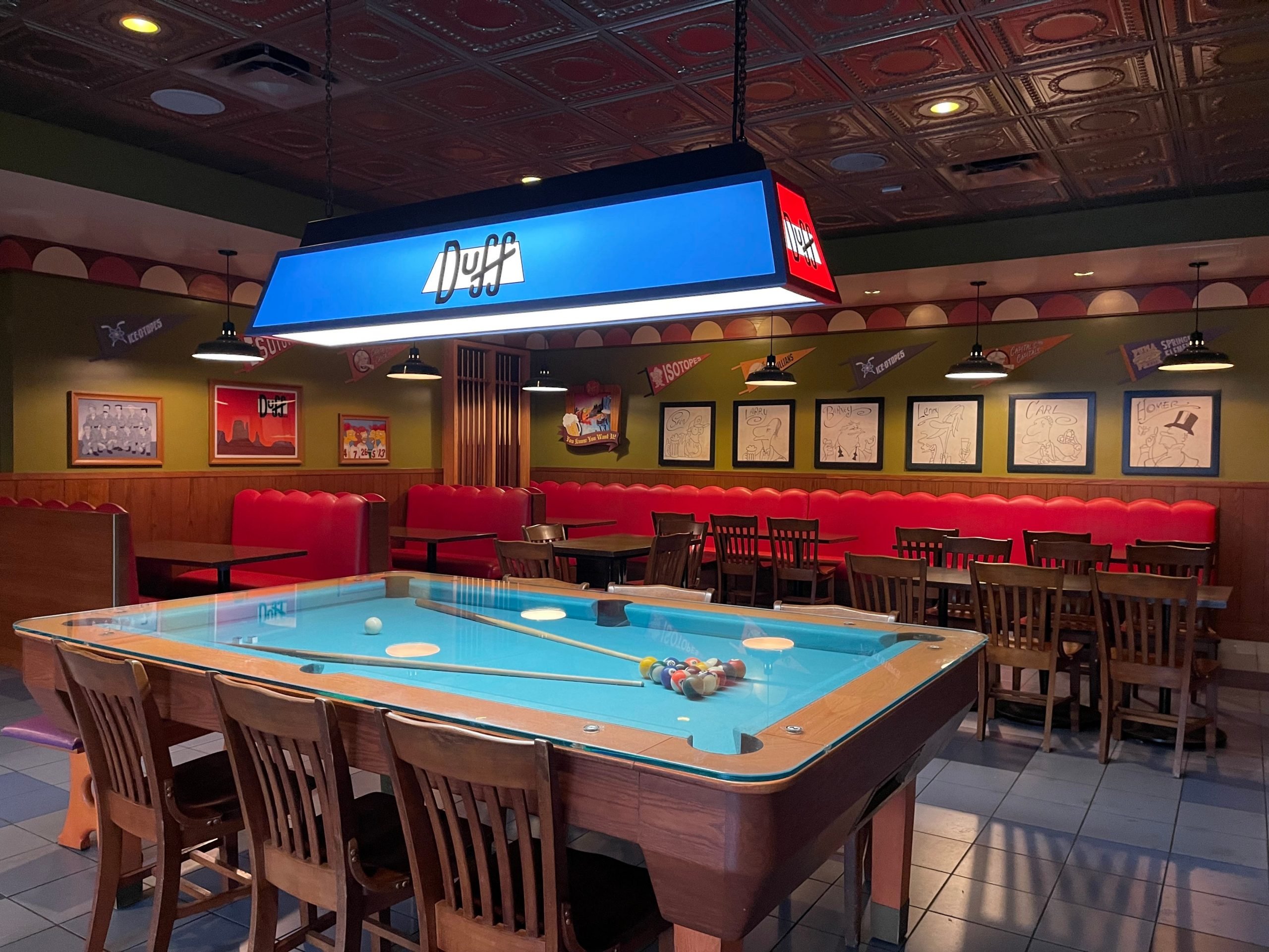 The inside of Moe's Tavern in Universal with a pool table table