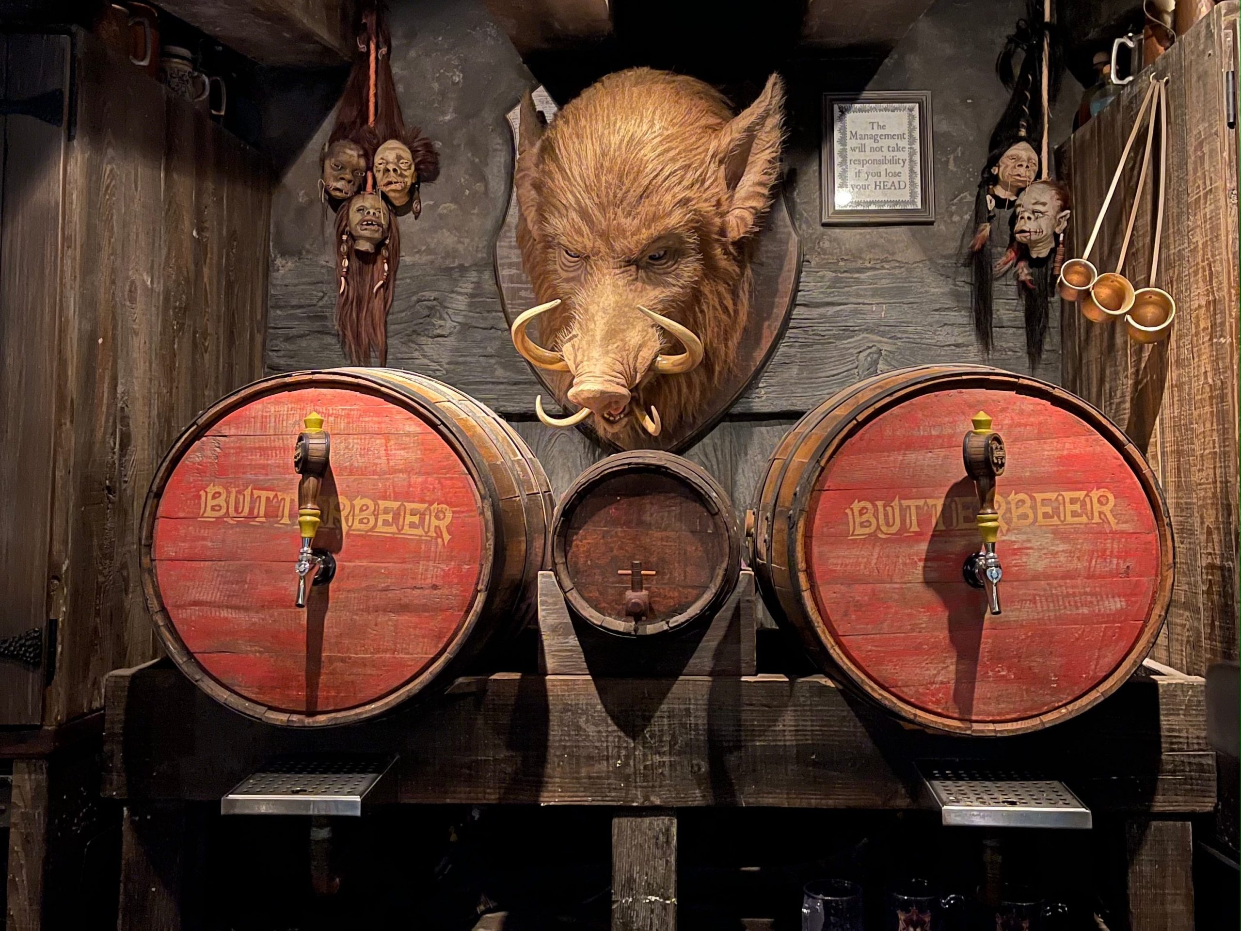 A wall in Hogs Head pub with a big hog and barrels