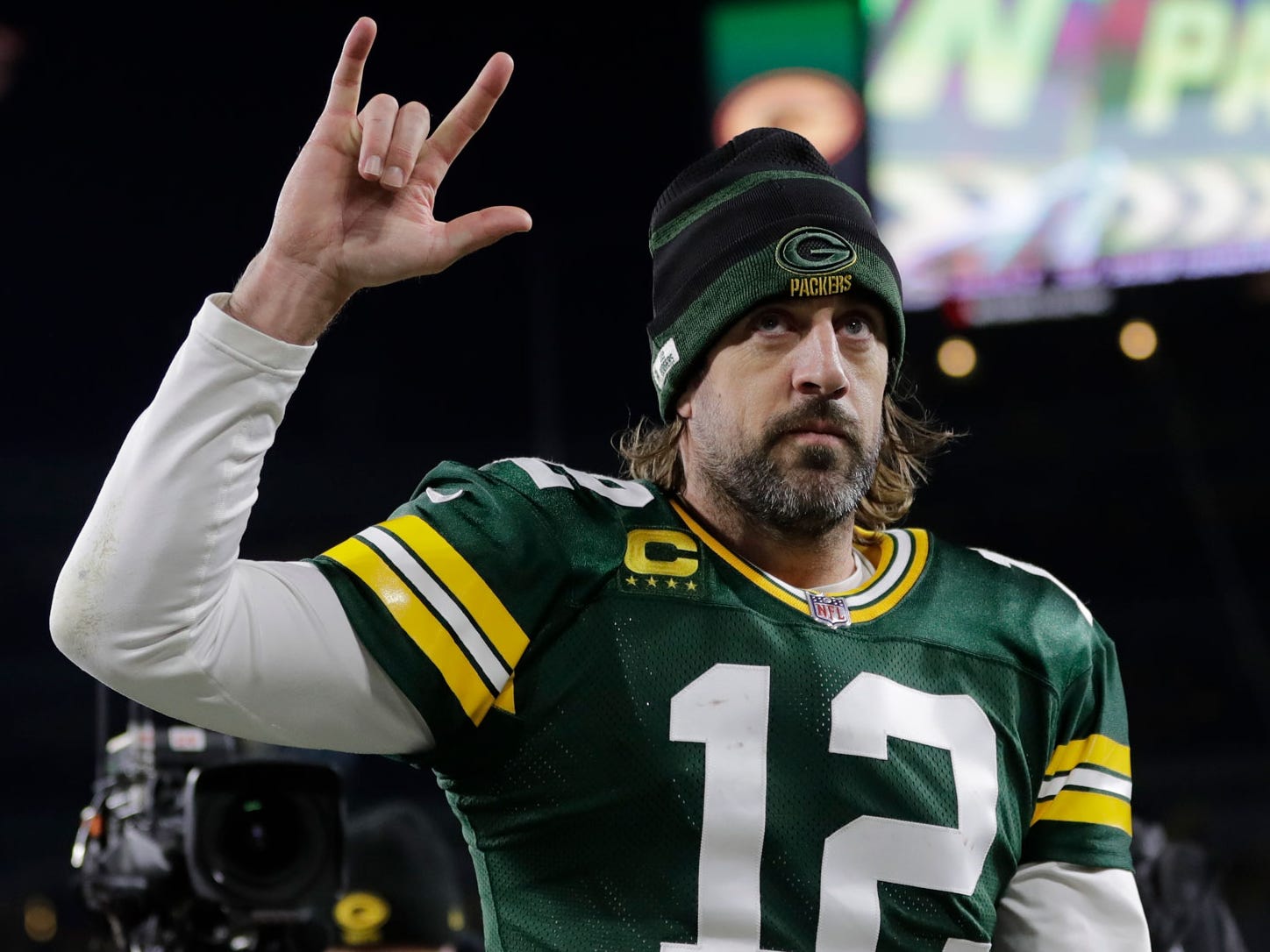 Aaron Rodgers walks off the field after a win against the Chicago Bears.