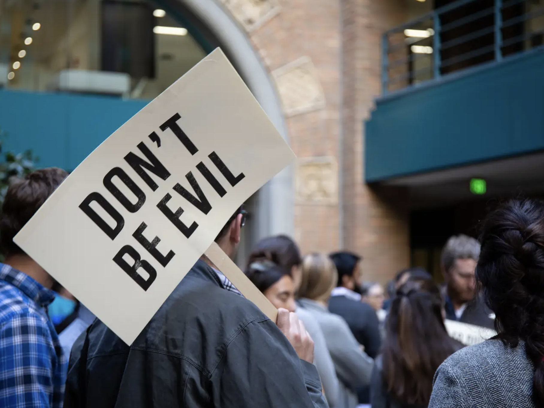 A Google employee holds a placard sporting the firm's motto 'Don't be evil' during the 2018 walkout