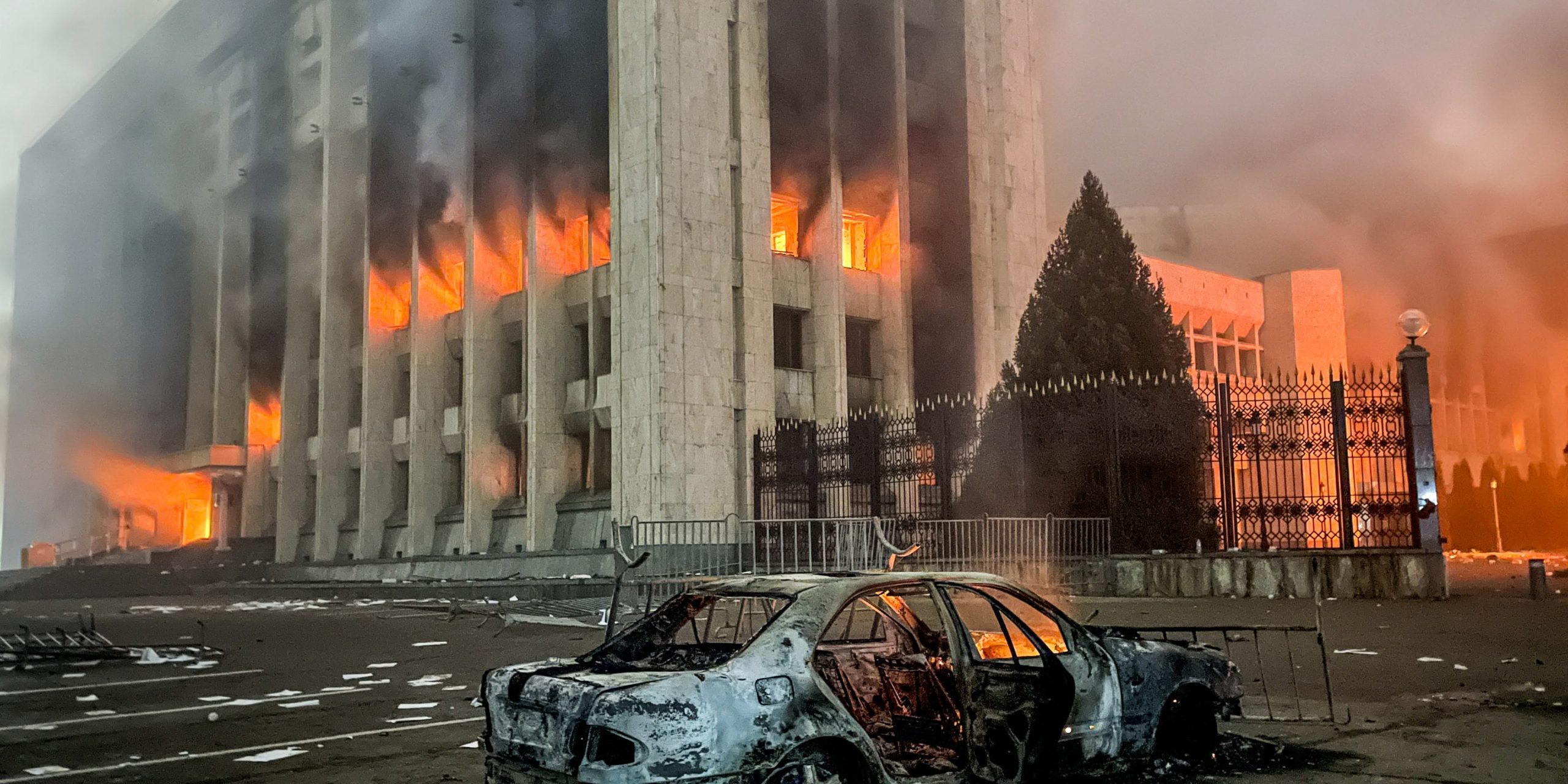 A burnt car is seen by the mayors office on fire. Protests are spreading across Kazakhstan over the rising fuel prices; protesters broke into the Almaty mayors office and set it on fire. Valery Sharifulin/TASS (Photo by Valery SharifulinTASS via Getty Images)