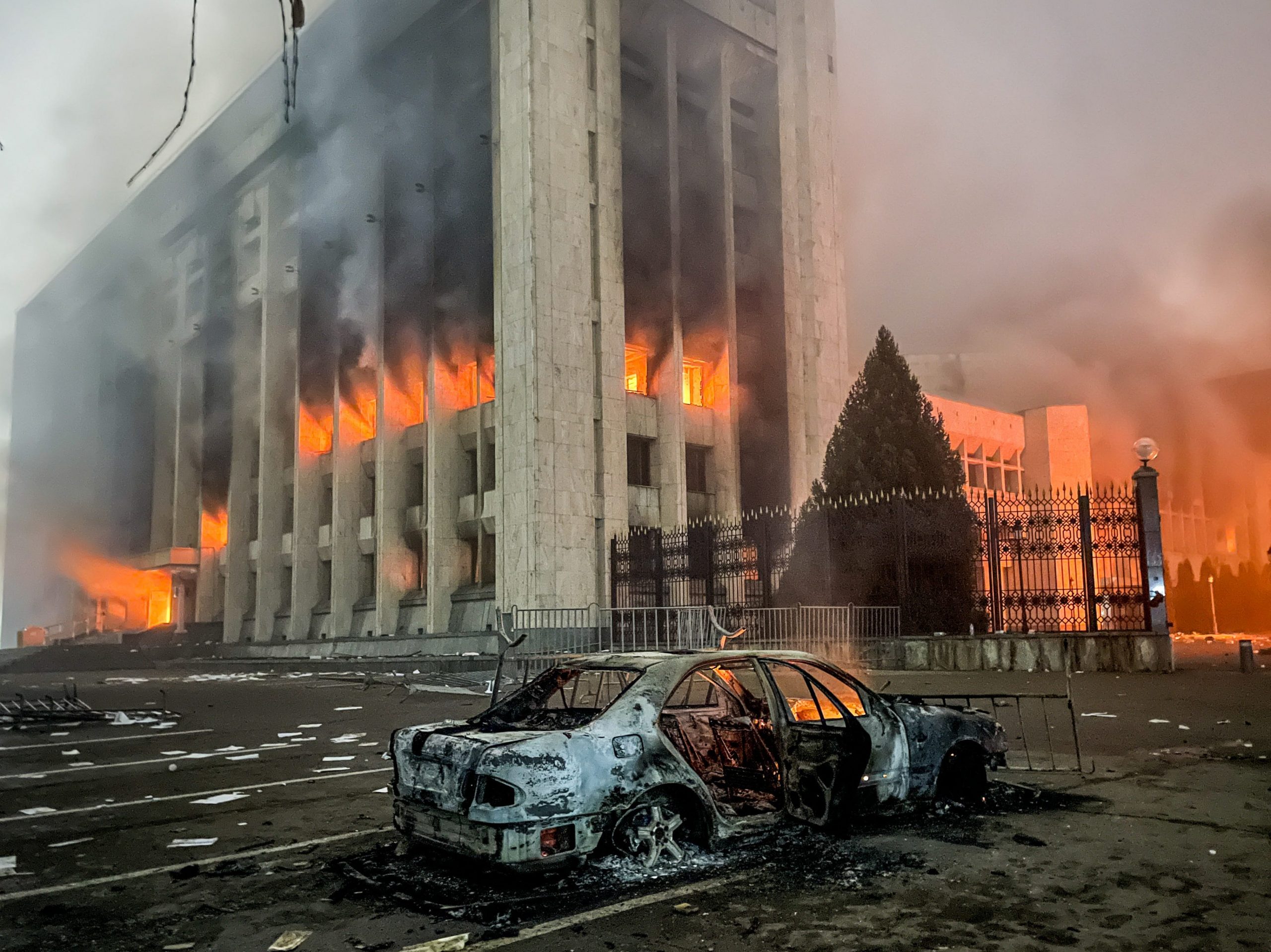 A burnt car is seen by the mayors office on fire. Protests are spreading across Kazakhstan over the rising fuel prices; protesters broke into the Almaty mayors office and set it on fire. Valery Sharifulin/TASS (Photo by Valery SharifulinTASS via Getty Images)