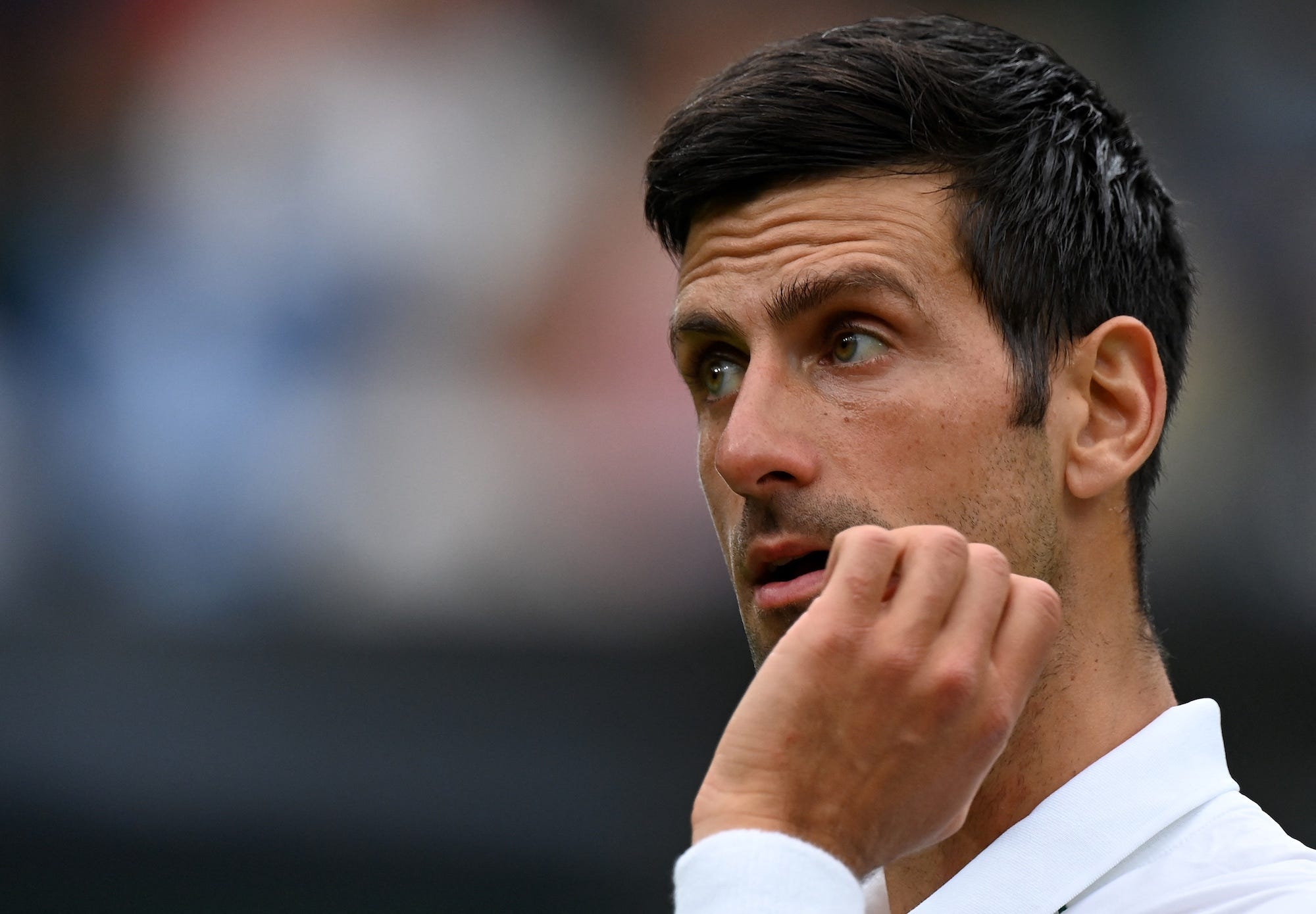 Serbia's Novak Djokovic reacts against Britain's Jack Draper during their men's singles first round match on the first day of the 2021 Wimbledon Championships at The All England Tennis Club in Wimbledon