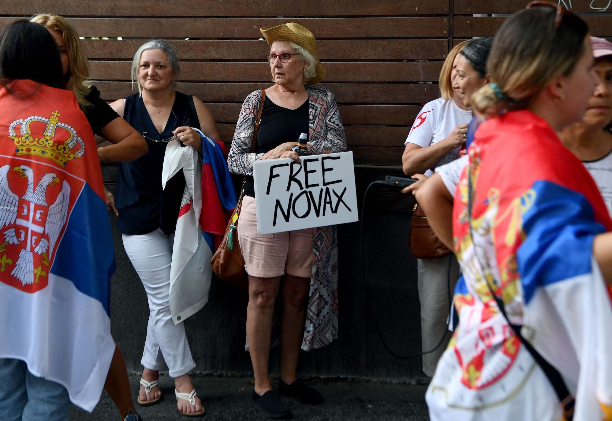 Supporters gather outside Park Hotel where Novak Djokovic was taken pending his removal from the country after his visa was cancelled by the Australian Border Force in Melbourne, Australia on January 06, 2022. Djokovic arrived in Melbourne to play in the upcoming Australian Open and was denied entry to Australia as border authorities cancelled his visa