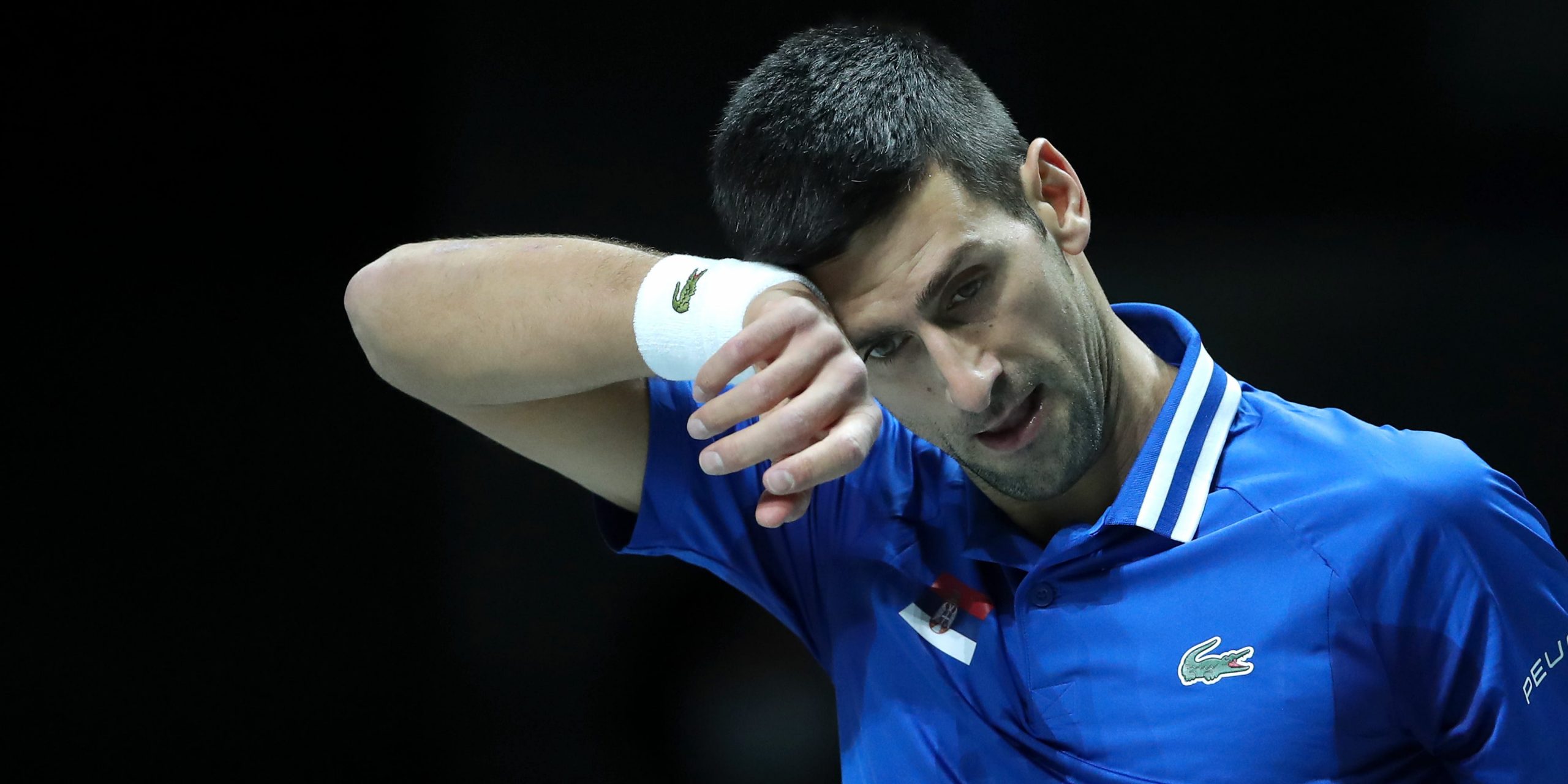 Novak Djokovic of Serbia wipes away sweat during the Davis Cup Semi Final match between Croatia and Serbia at Madrid Arena on December 03, 2021 in Madrid, Spain.