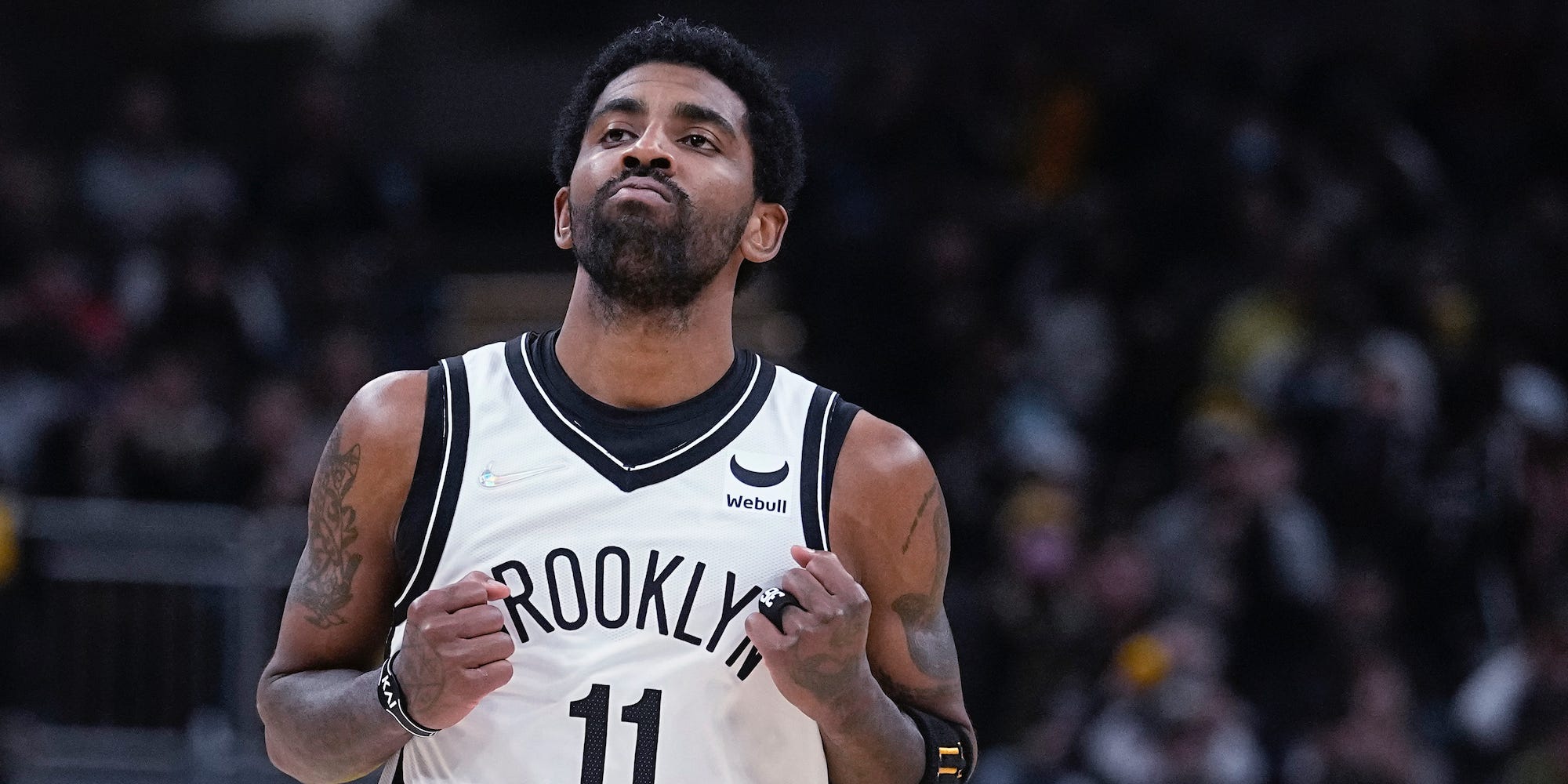 Kyrie Irving clenches his fists and looks up.
