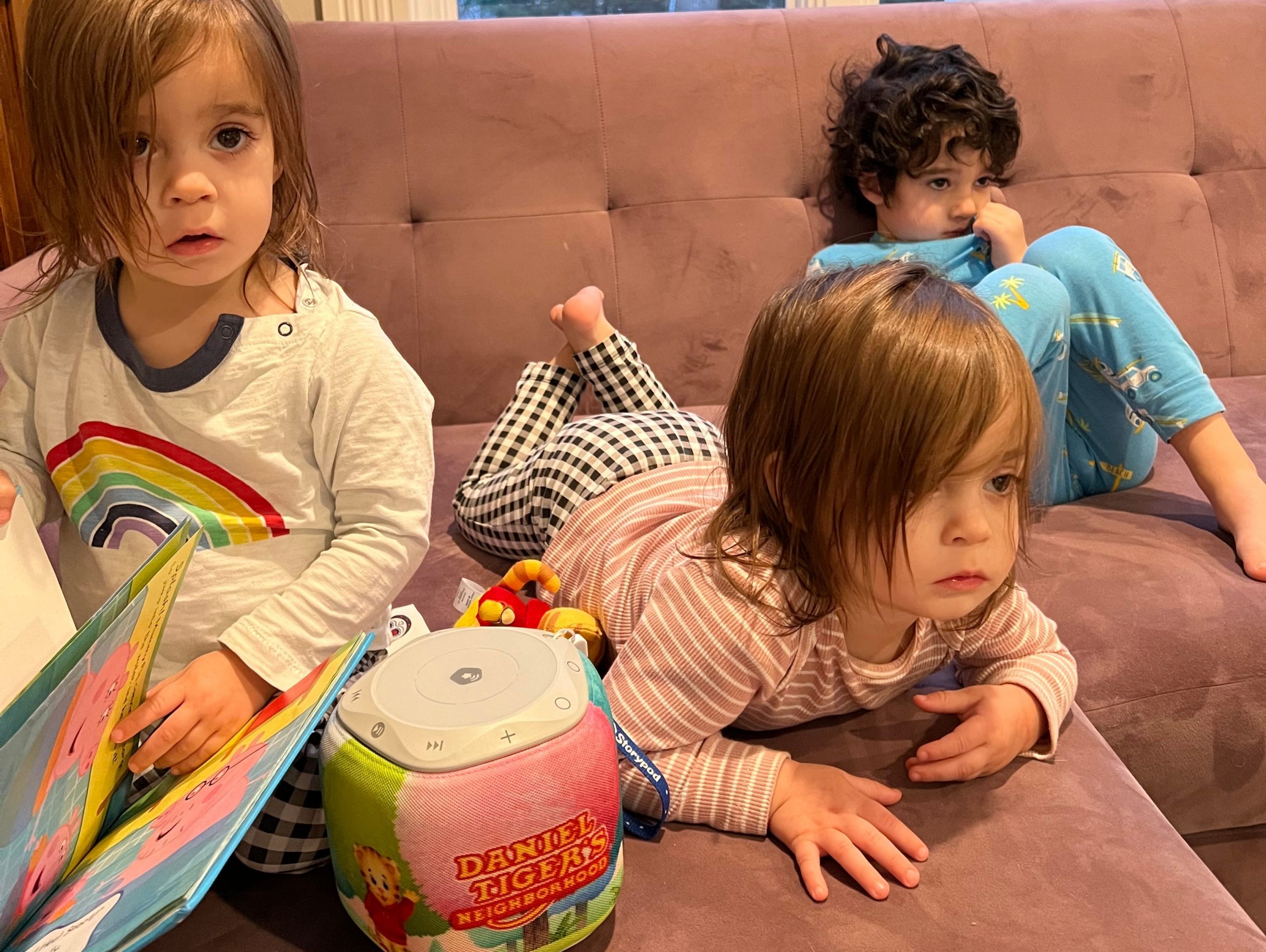 Three kids watching TV