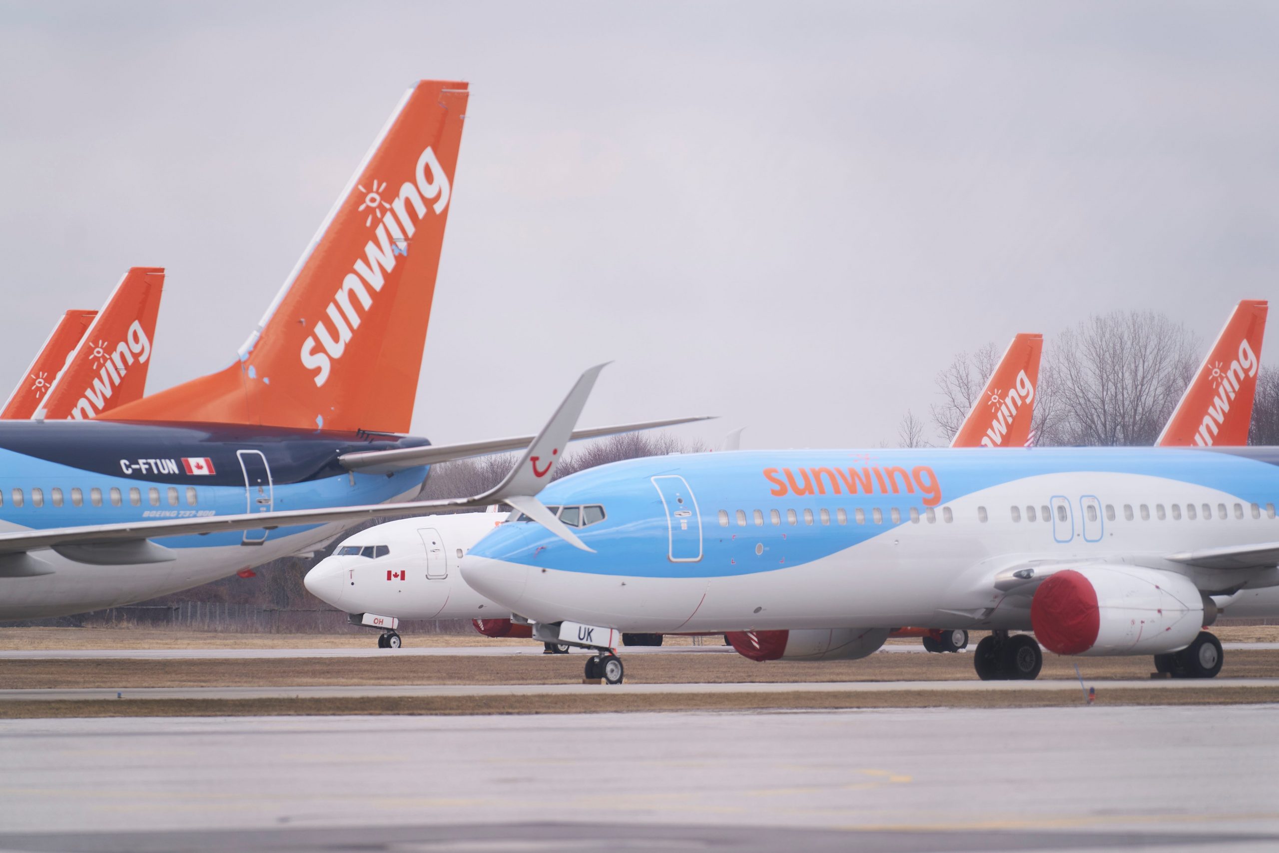 oeing 737s belonging to Canadian Vacation air carrier Sunwing sit on the tarmac at Waterloo International Airport in Waterloo, Ontario on March 24, 2020.