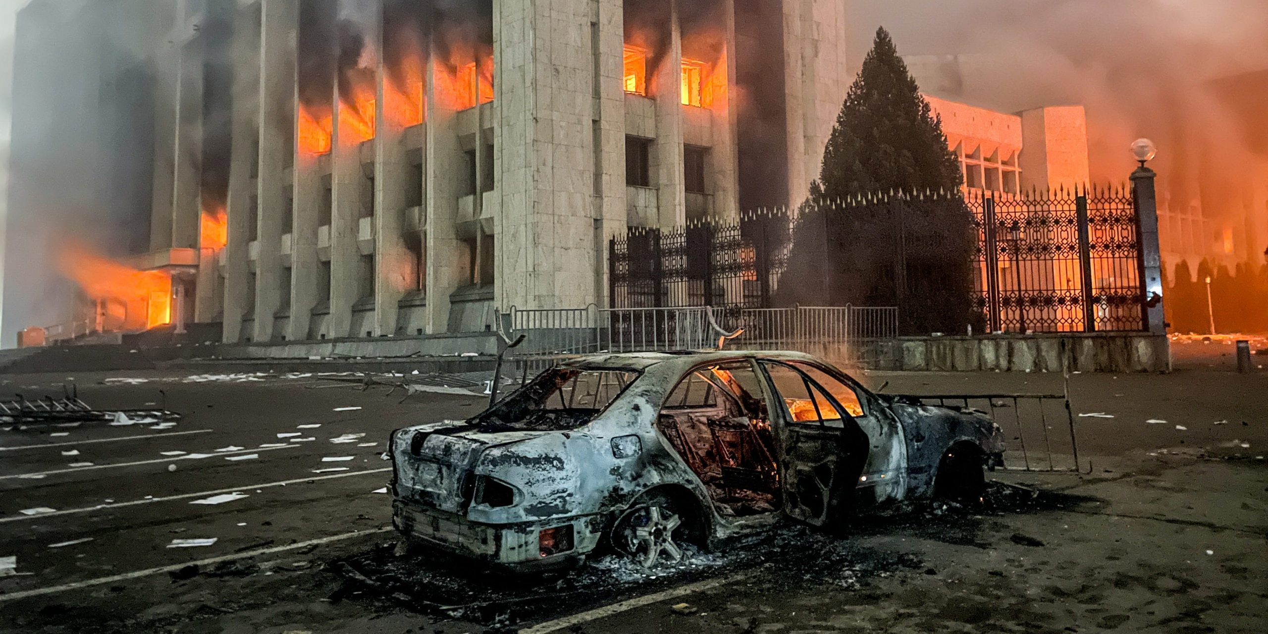 A burnt car is seen by the mayors office on fire. Protests are spreading across Kazakhstan over the rising fuel prices; protesters broke into the Almaty mayors office and set it on fire. Valery Sharifulin/TASS (Photo by Valery SharifulinTASS via Getty Images)