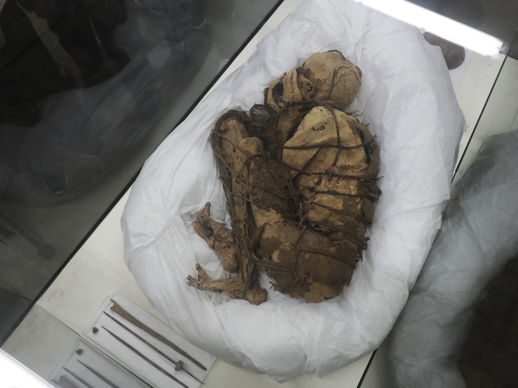 The "mummy of Cajamarquilla" is seen from an arial view, showing the body bound in a fetal position.