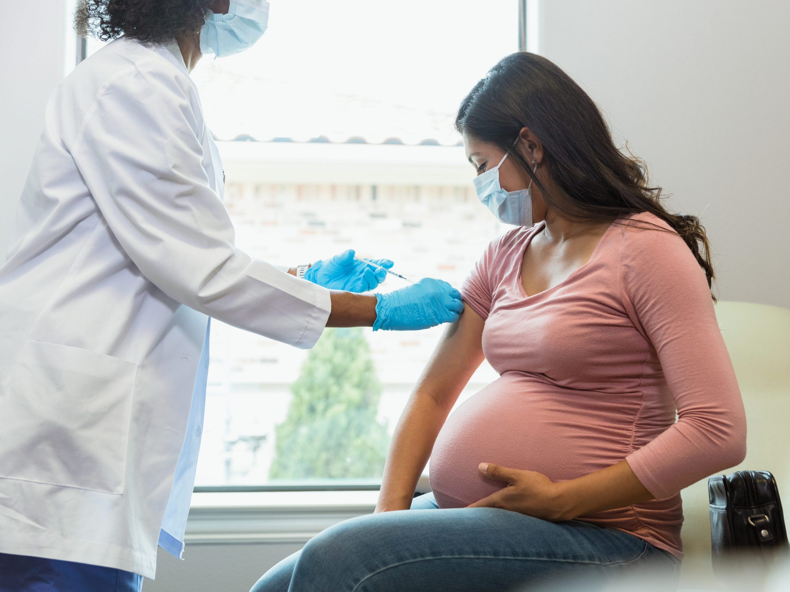 A pregnant woman getting a vaccine