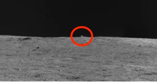 cube-shaped rock on the lunar horizon