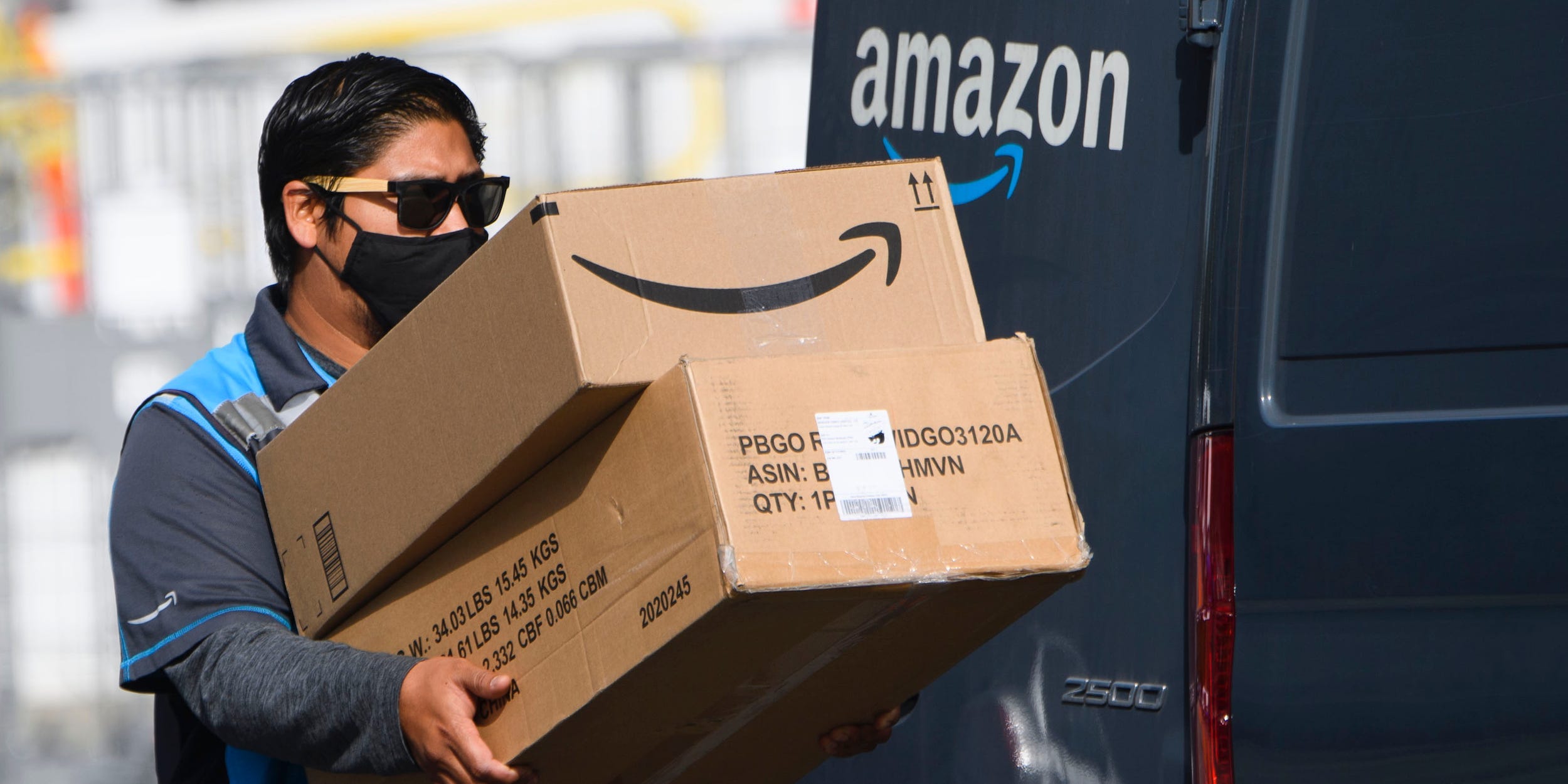 An Amazon driver carrying packages.