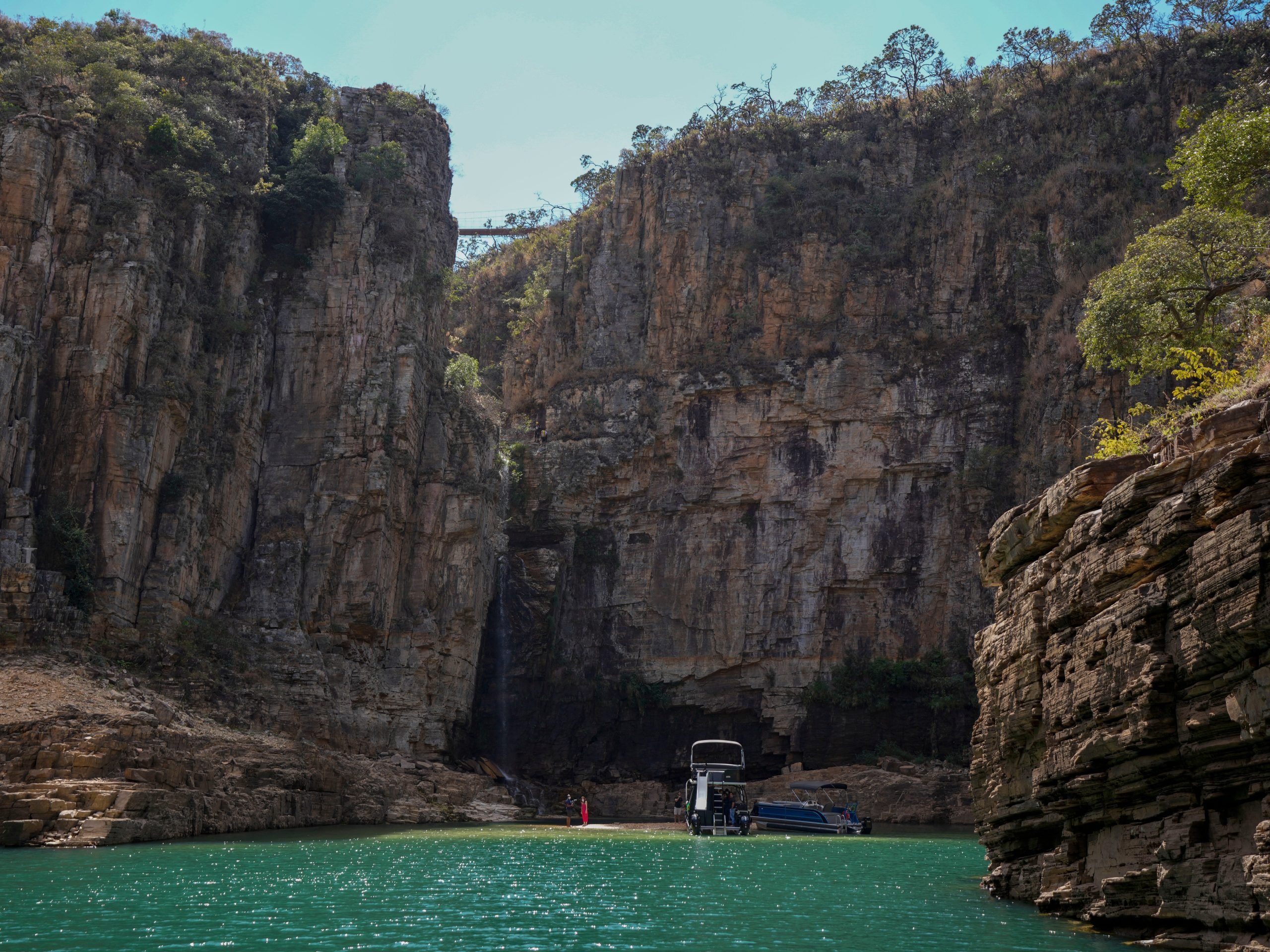 A tourist boat navigates through a canyon in Furnas Lake, near Capitolio City, Brazil, Sept. 2, 2021.