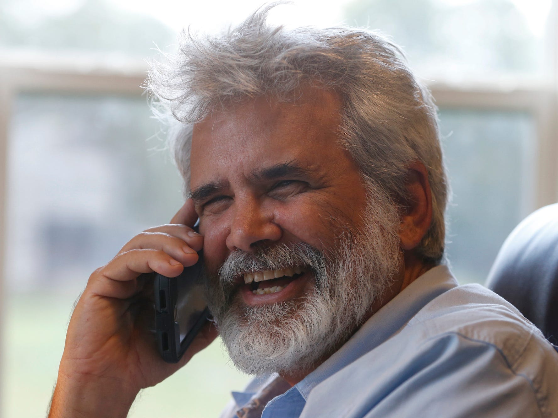 Dr. Robert Malone talks on his phone as he works from his office on his horse farm Wednesday July 22, 2020, in Madison, Va.