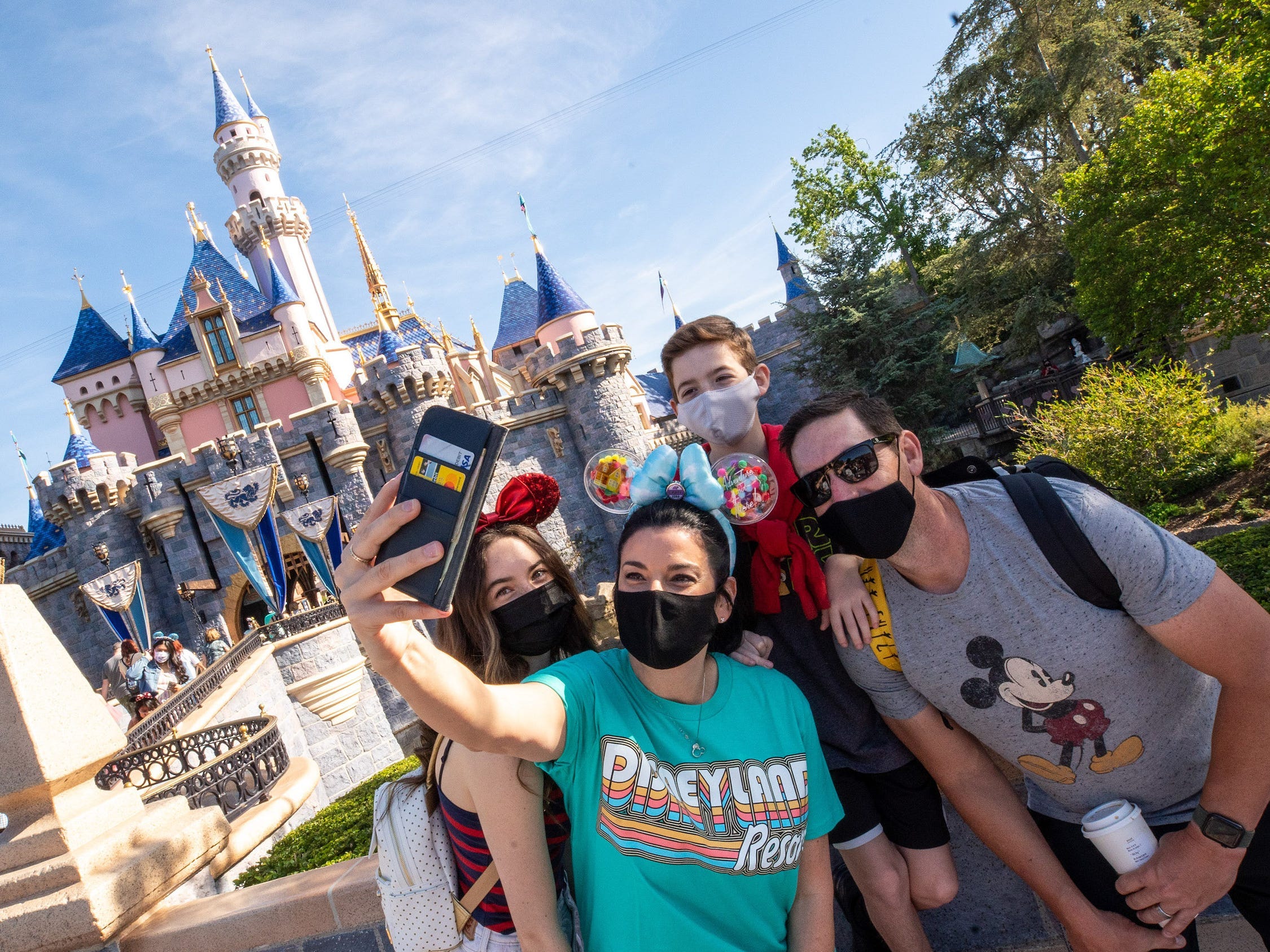 Visitors pose for a selfie at the Disneyland Resort on April 30, 2021 in Anaheim, California