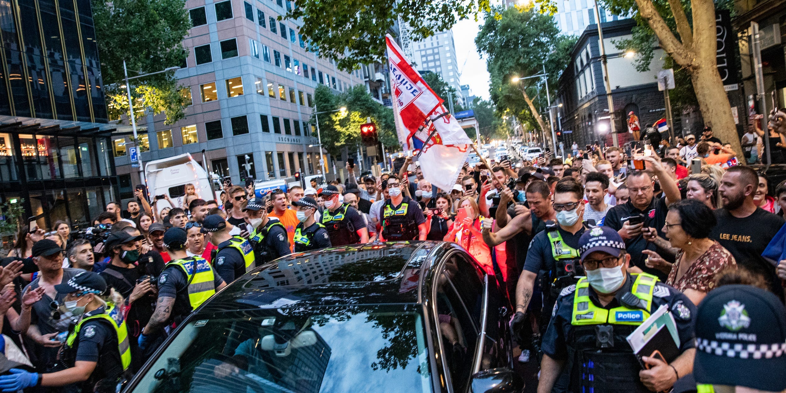 Fans mob a car in Melbourne in which they believe Novak Djokovic is riding on January 10, 2022.