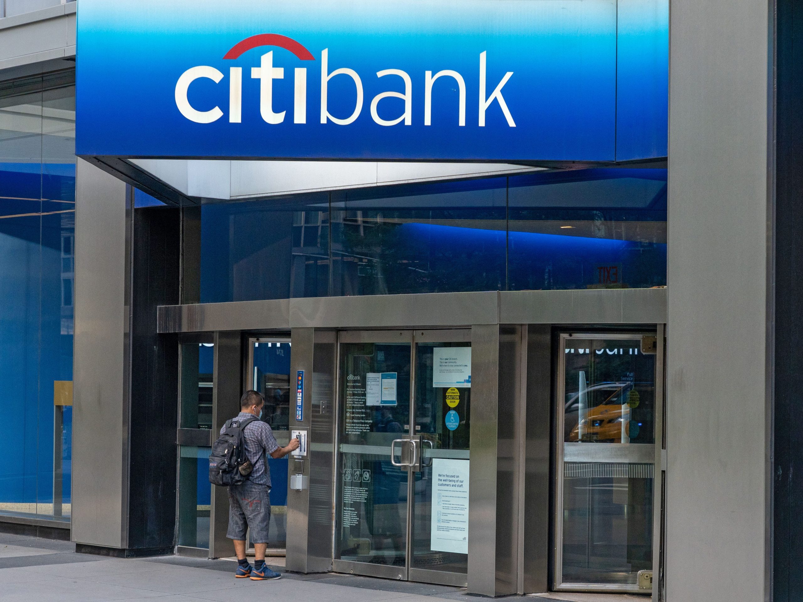 A man enters a Citibank branch of Citigroup in New York City. Profit plummeted at the bank because of COVID-19 pandemic