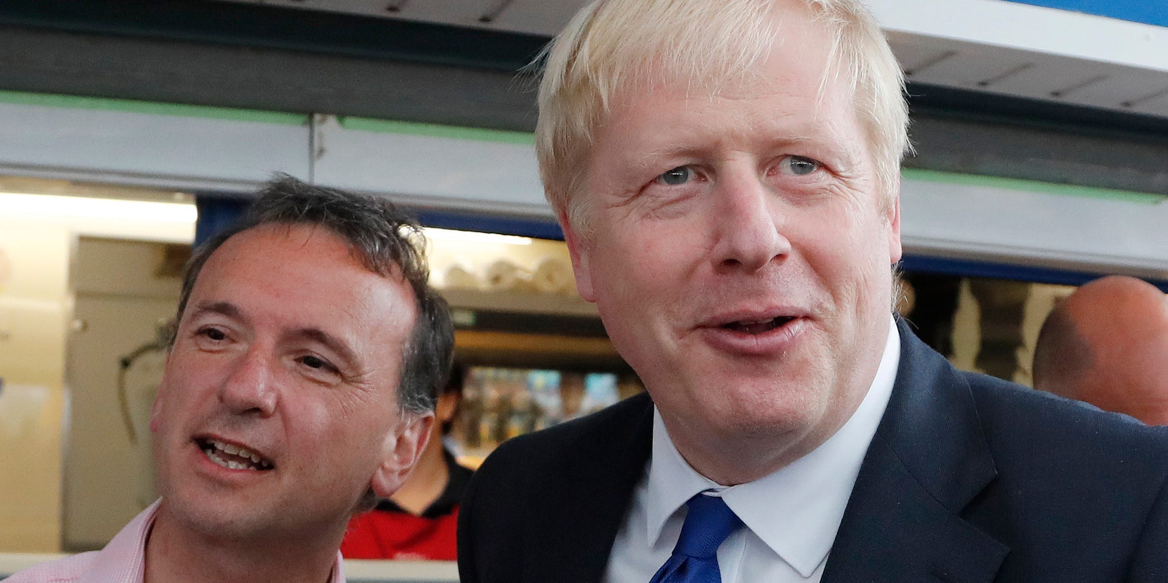 Alun Cairns and Boris Johnson holding ice creams with Welsh and British flags in them.