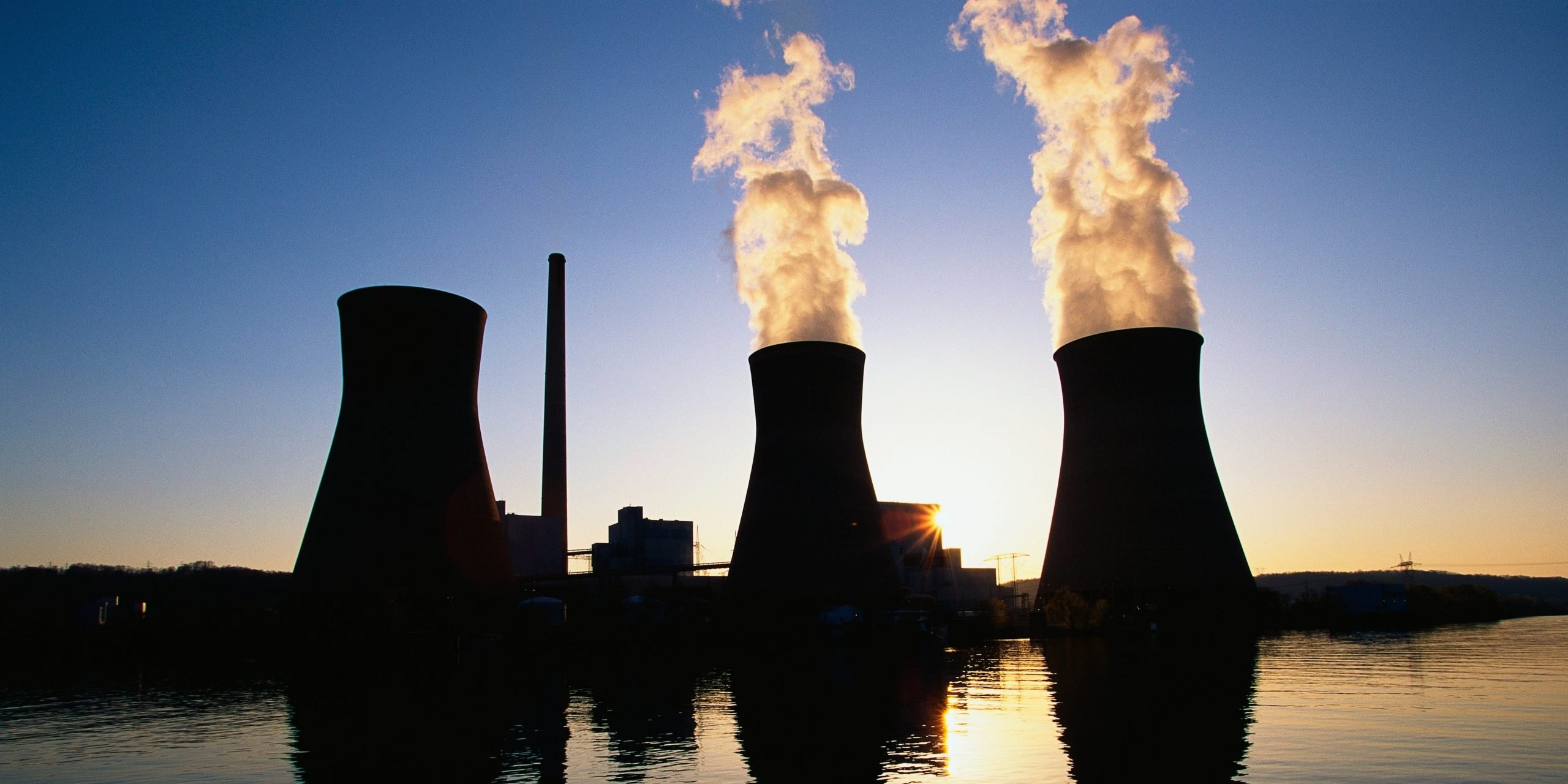 Three stacks at the John Ames Power Plant. It is a coal utility company located on the Kanoa River at sunset