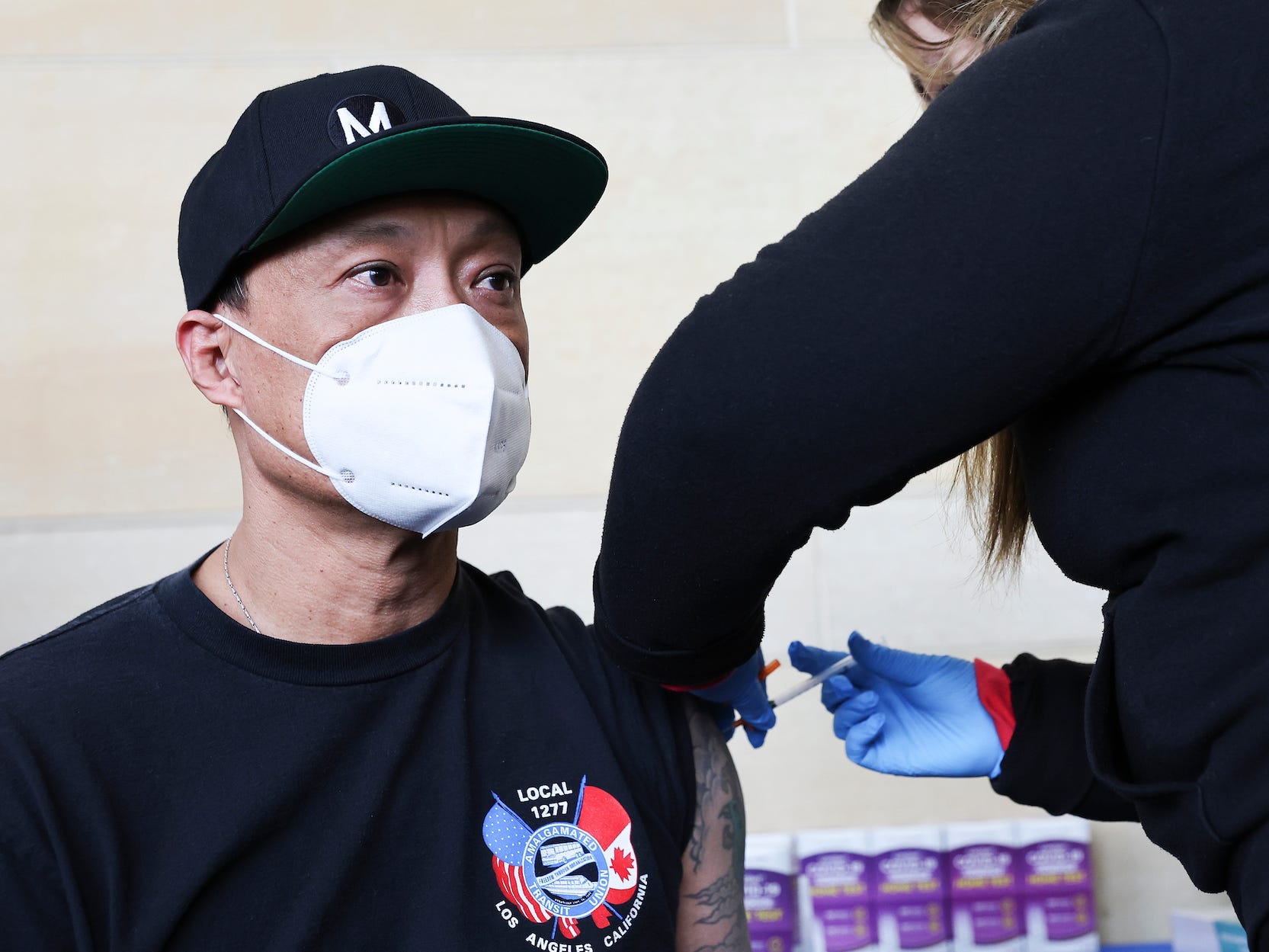 A man wearing a mask is getting a COVID-19 vaccination in Los Angeles, US, on January 7, 2022/