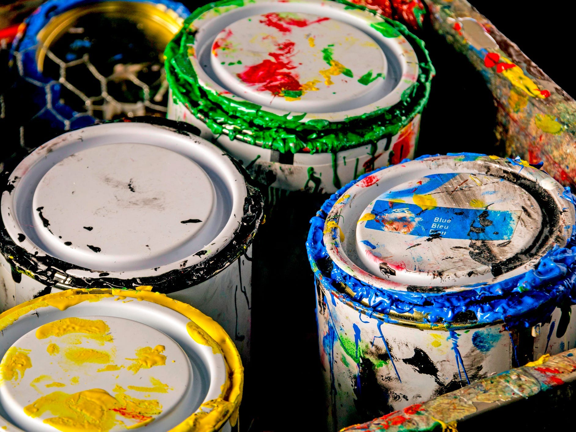 Old paint cans in a wooden box