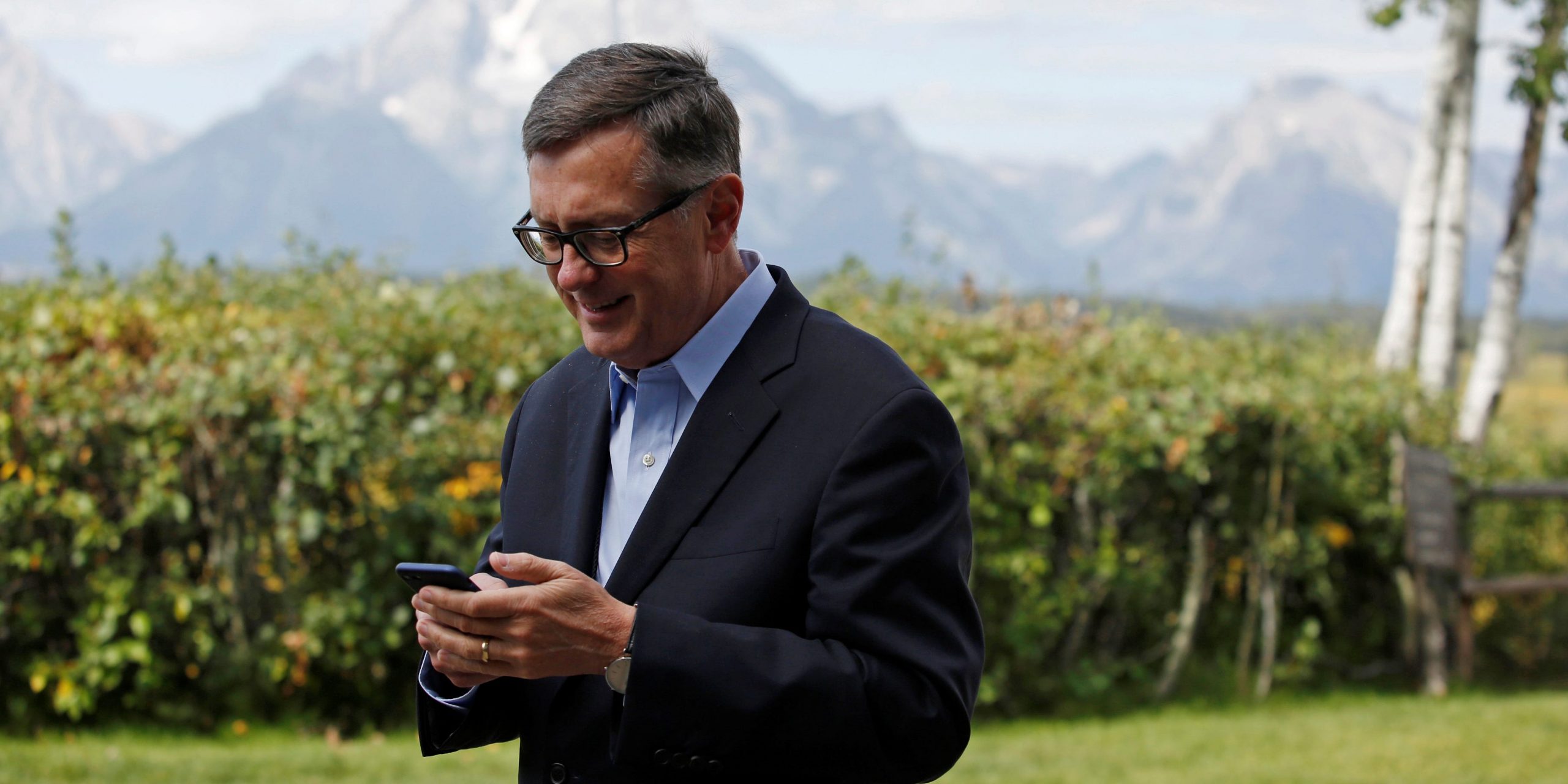 FILE PHOTO: Federal Reserve Vice Chair Richard Clarida reacts as he holds his phone during the three-day "Challenges for Monetary Policy" conference in Jackson Hole, Wyoming, U.S., August 23, 2019.  REUTERS/Jonathan Crosby