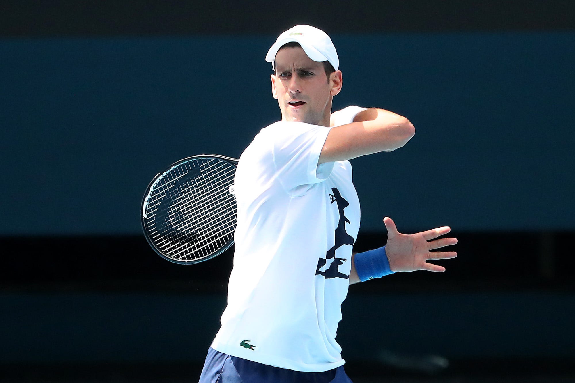 Novak Djokovic of Serbia practices on Rod Laver Arena ahead of the 2022 Australian Open at Melbourne Park on January 11, 2022 in Melbourne, Australia. Djokovic arrived in Melbourne on Thursday night to play in the upcoming Australian Open and was denied entry to Australia due to his inability to meet Australian entry requirements. He was sent to an immigration detention hotel while the decision to cancel his visa was reviewed in the Australian Federal Circuit Court. Djokovic was granted permission to enter Australia on Monday night and resumed practising soon after with another session this afternoon, while the Federal Government decides if they should still cancel his visa