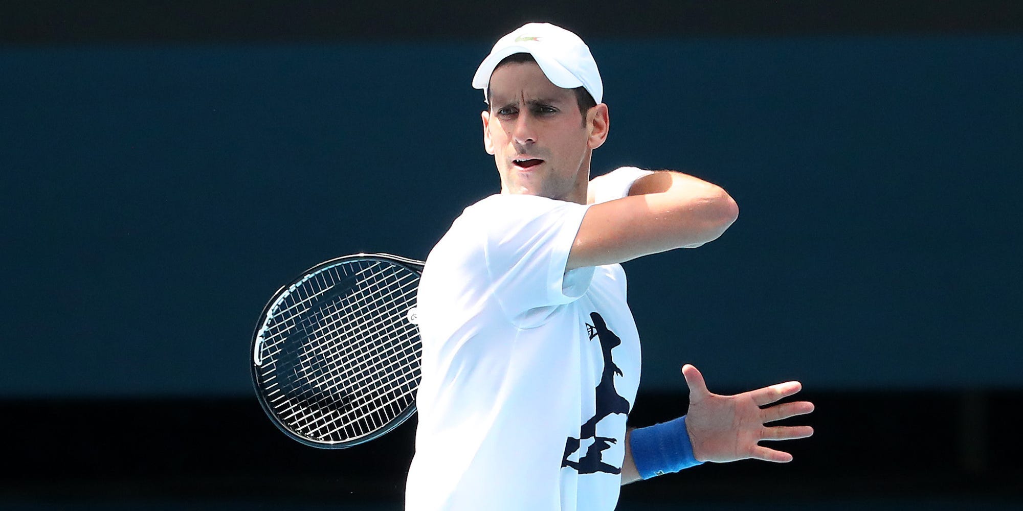 Novak Djokovic of Serbia practices on Rod Laver Arena ahead of the 2022 Australian Open at Melbourne Park on January 11, 2022 in Melbourne, Australia. Djokovic arrived in Melbourne on Thursday night to play in the upcoming Australian Open and was denied entry to Australia due to his inability to meet Australian entry requirements. He was sent to an immigration detention hotel while the decision to cancel his visa was reviewed in the Australian Federal Circuit Court. Djokovic was granted permission to enter Australia on Monday night and resumed practising soon after with another session this afternoon, while the Federal Government decides if they should still cancel his visa