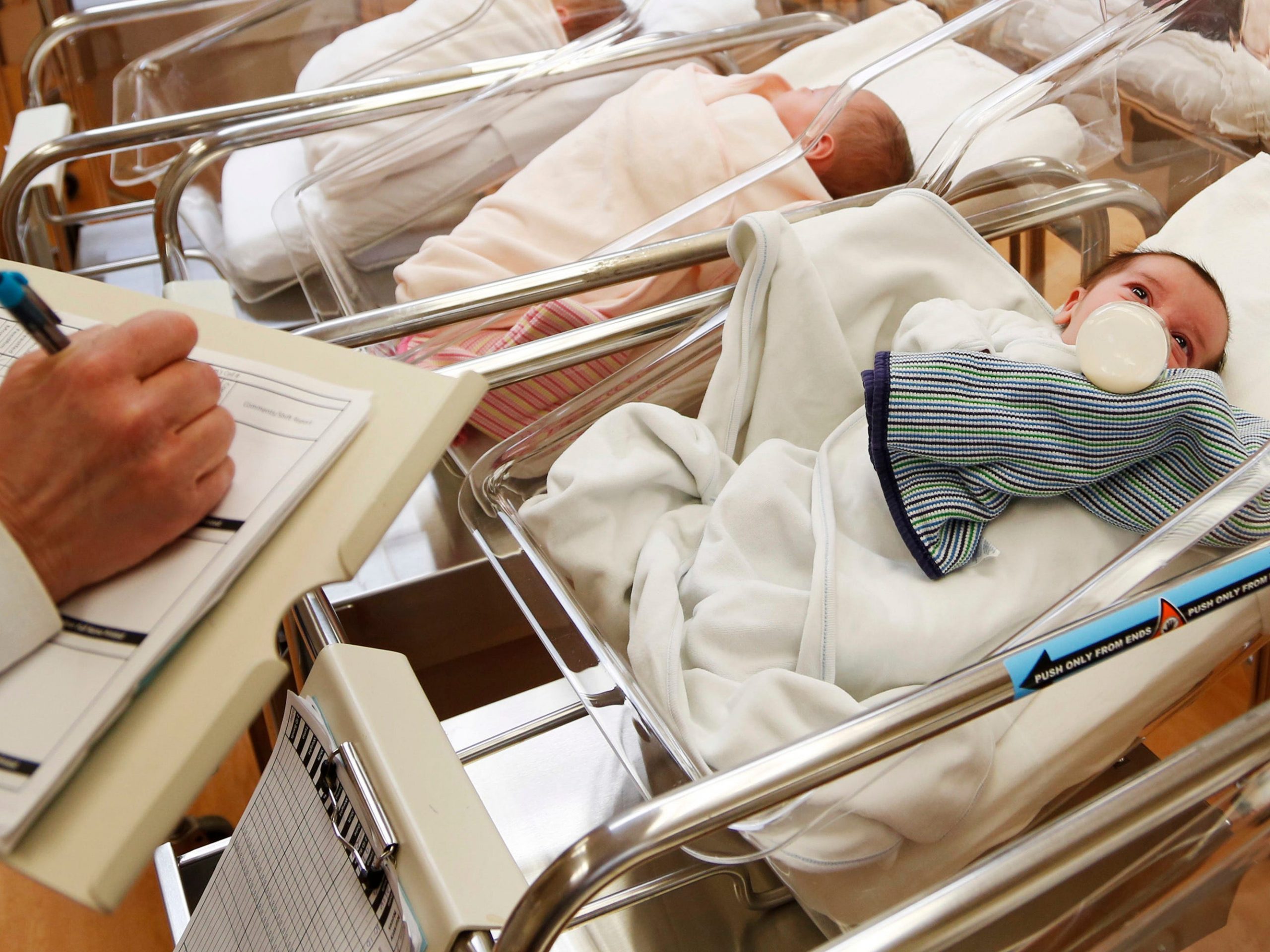 FILE - This Feb. 16, 2017 file photo shows newborn babies in the nursery of a postpartum recovery center in upstate New York. According to a government report released Wednesday, May 15, 2019, U.S. birth rates reached record lows for women in their teens and 20s, leading to the fewest babies in 32 years. (AP Photo/Seth Wenig, File)