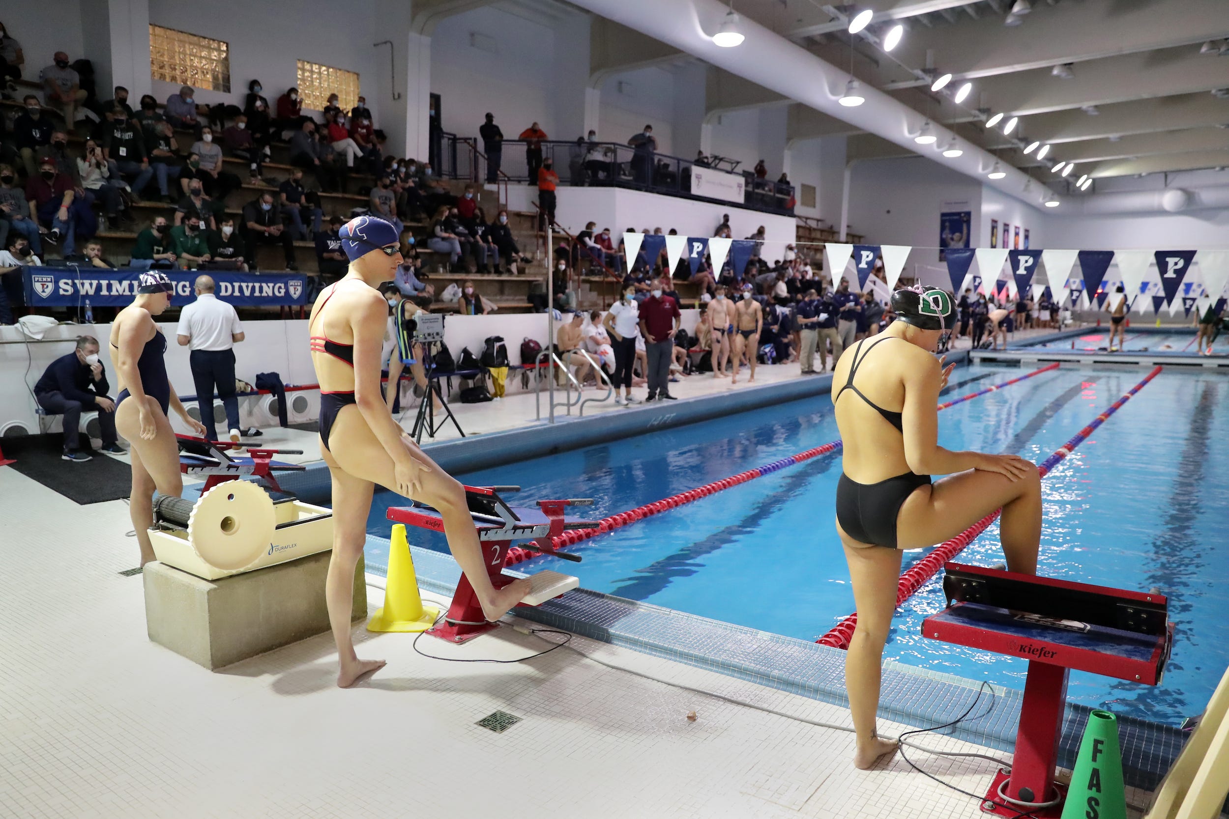 Lia Thomas (center) prepares for a race.