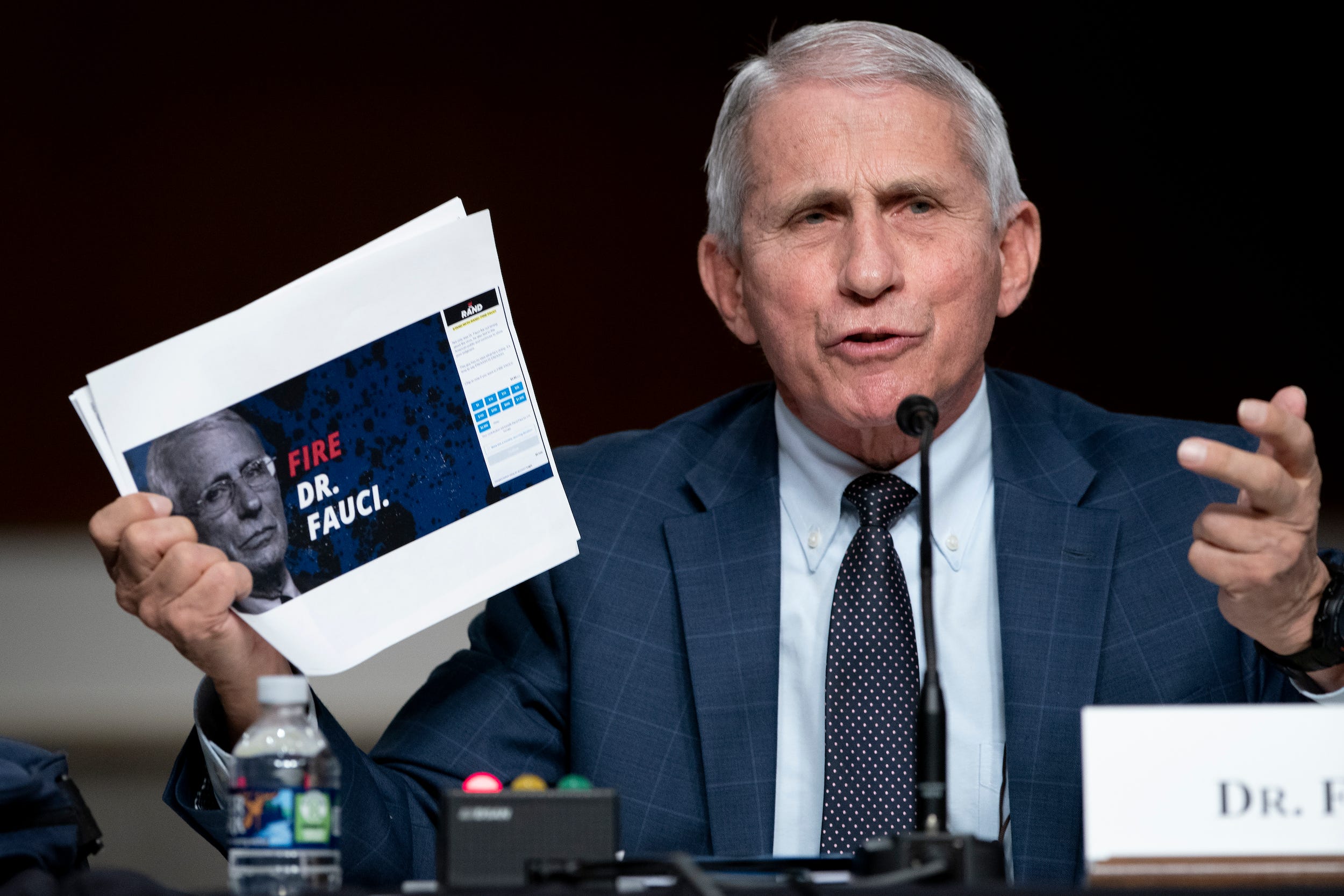 Anthony Fauci holds up a print-out during a Senate hearing