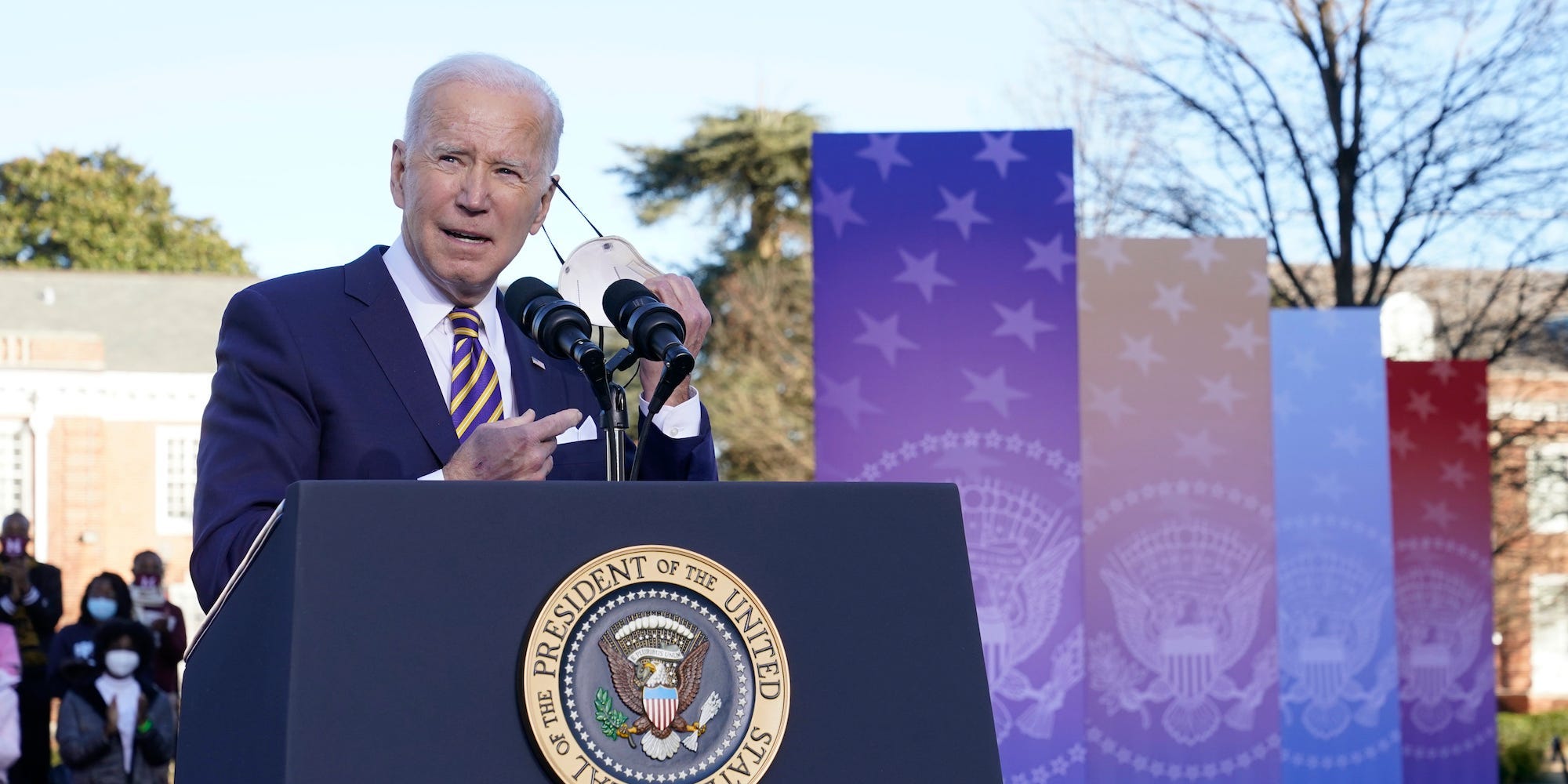 President Joe Biden takes off his face mask as he prepares to speak in support of changing the Senate filibuster rules that have stalled voting rights legislation, at Atlanta University Center Consortium, on the grounds of Morehouse College and Clark Atlanta University, Tuesday, Jan. 11, 2022, in Atlanta