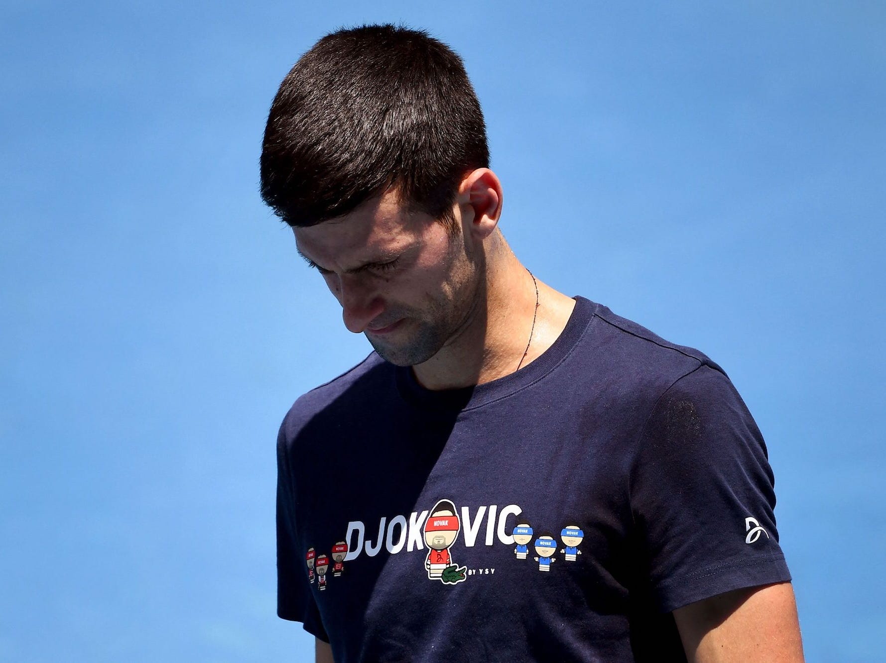Novak Djokovic of Serbia looks at his racquet during a practice session ahead of the Australian Open at the Melbourne Park tennis centre in Melbourne