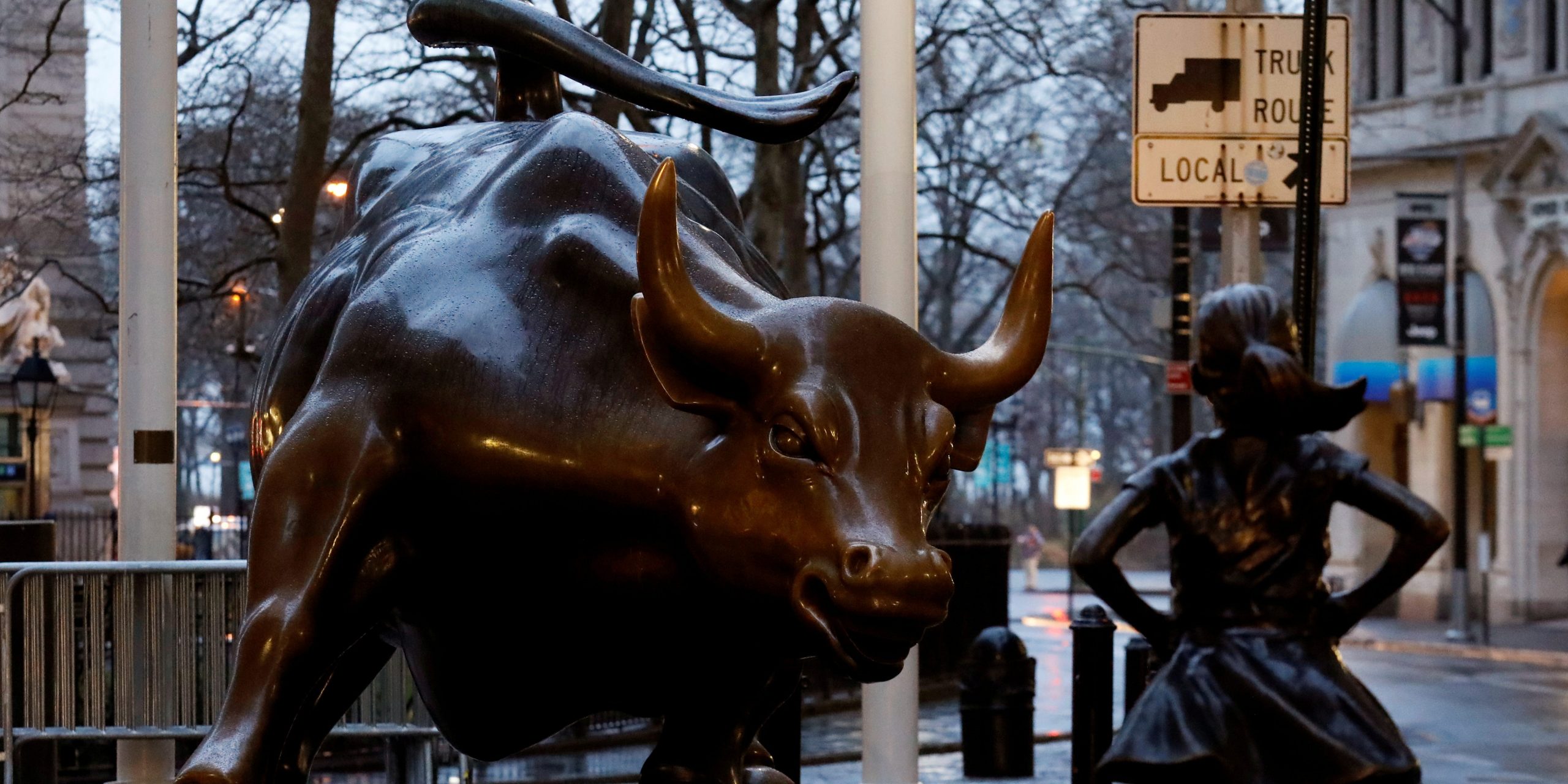 A statue of a girl facing the Wall St. Bull is seen in the financial district in New York