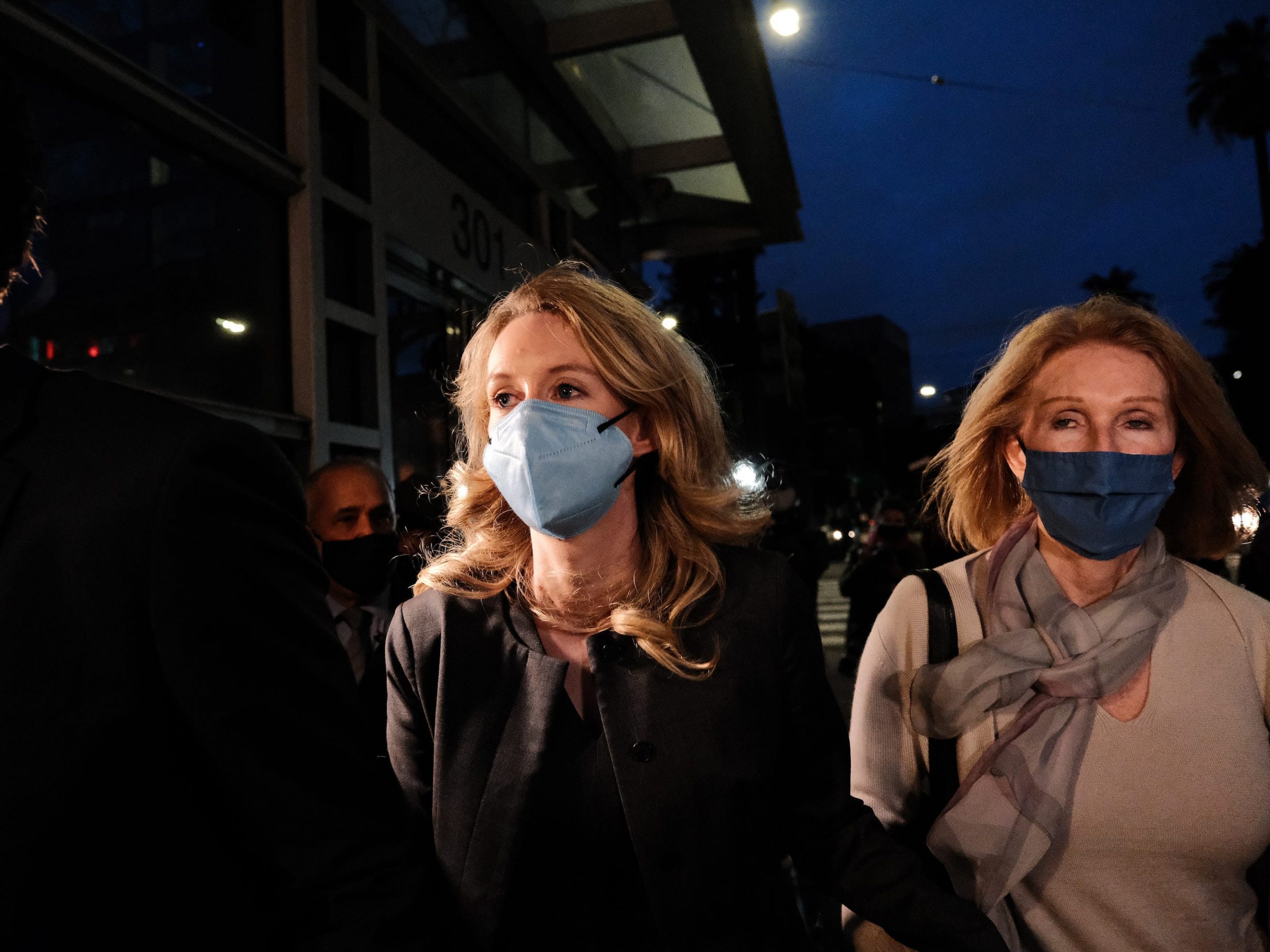 Theranos founder and former CEO Elizabeth Holmes (C) and her mother Noel Holmes leave the Robert F. Peckham Federal Building on January 3, 2022 in San Jose, California.