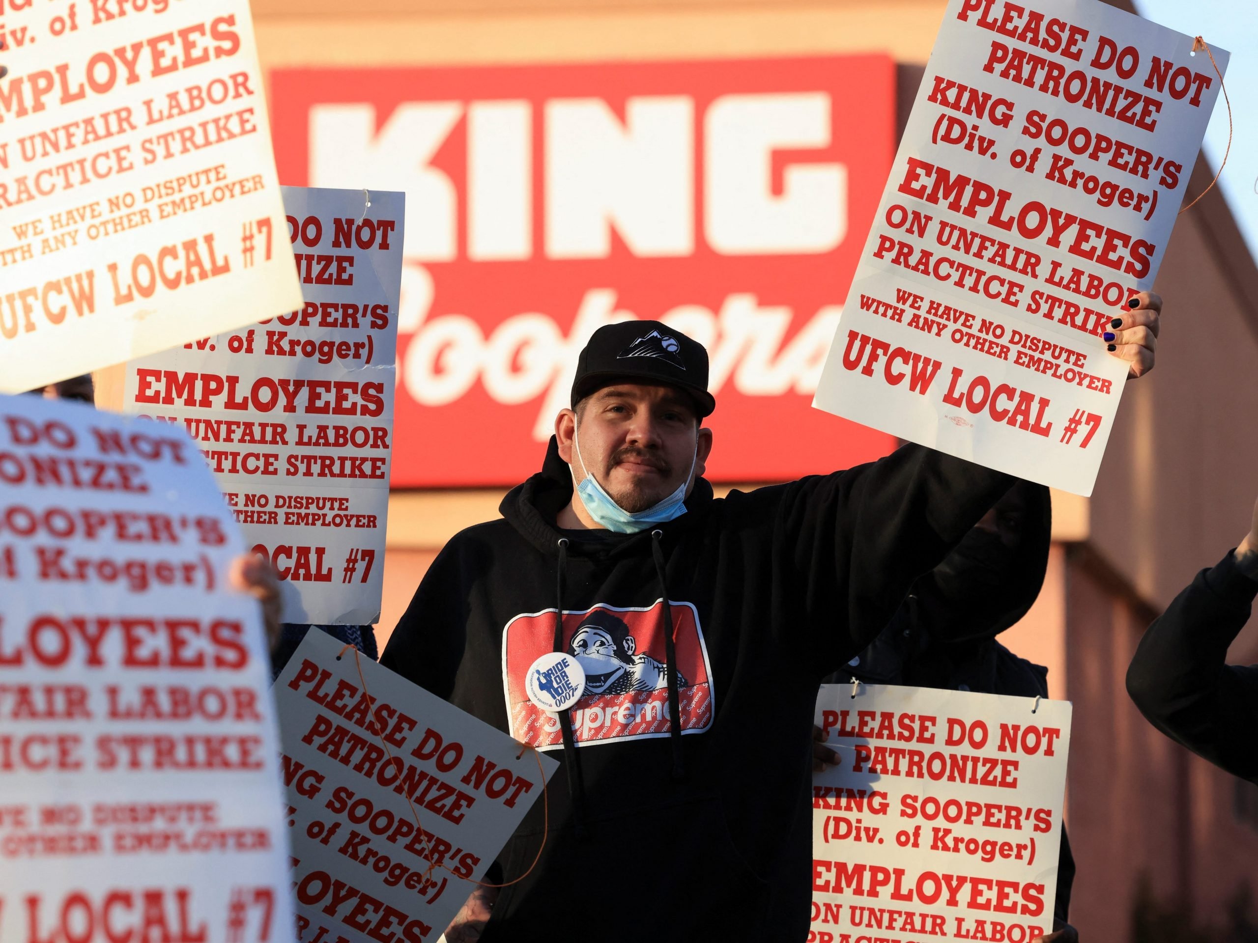 Union members raise signs outside a King Soopers store during a protest as workers go on strike in Denver, Colorado, U.S., January 12, 2022.