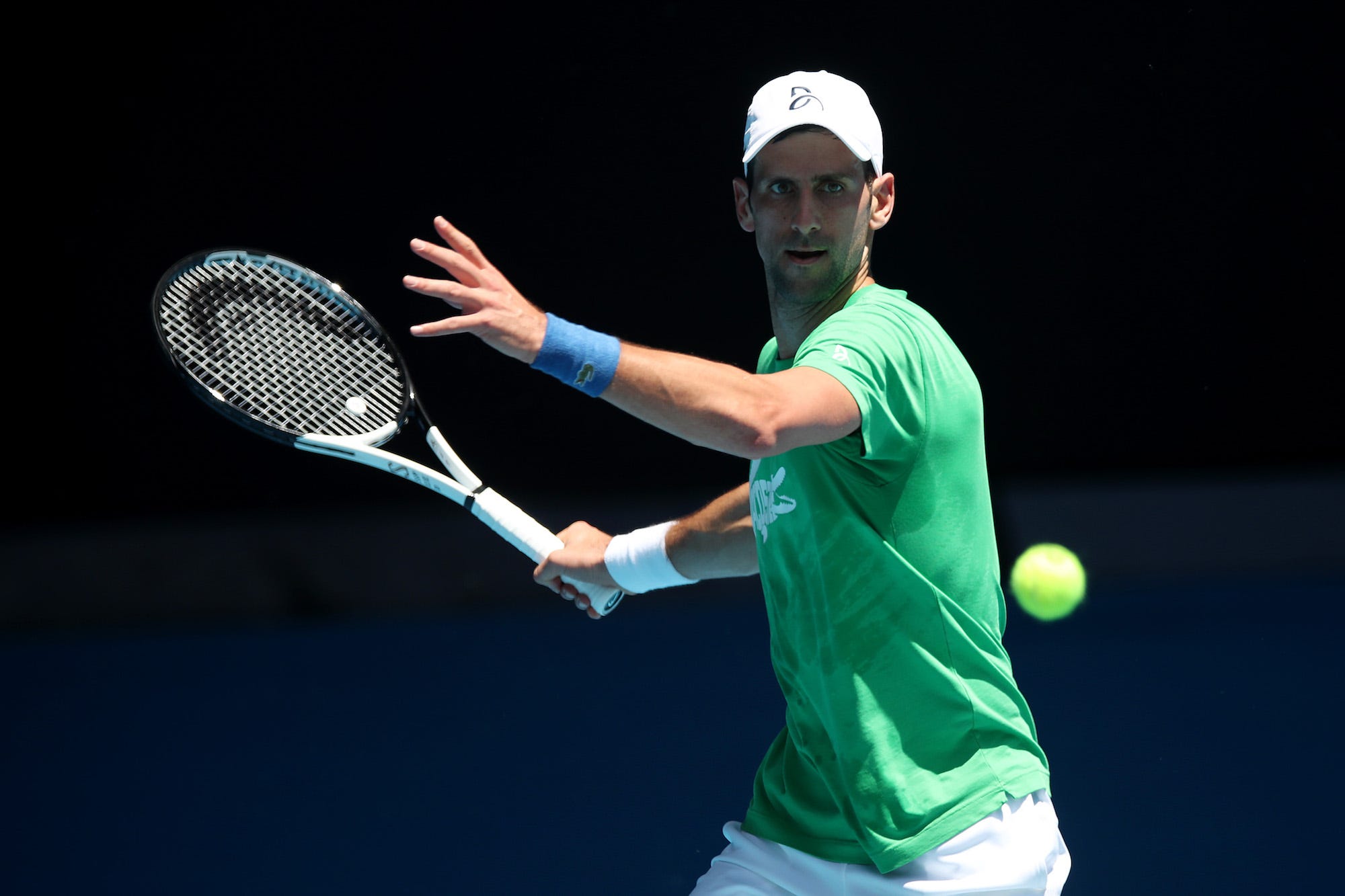 Novak Djokovic of Serbia plays a forehand during a practice session ahead of the 2022 Australian Open at Melbourne Park