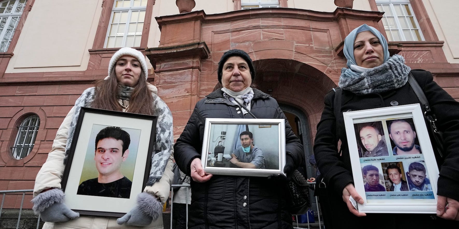 Syrian women hold pictures of relatives who died before the verdict in front of the court in Koblenz, Germany, Thursday, Jan. 13, 2022.
