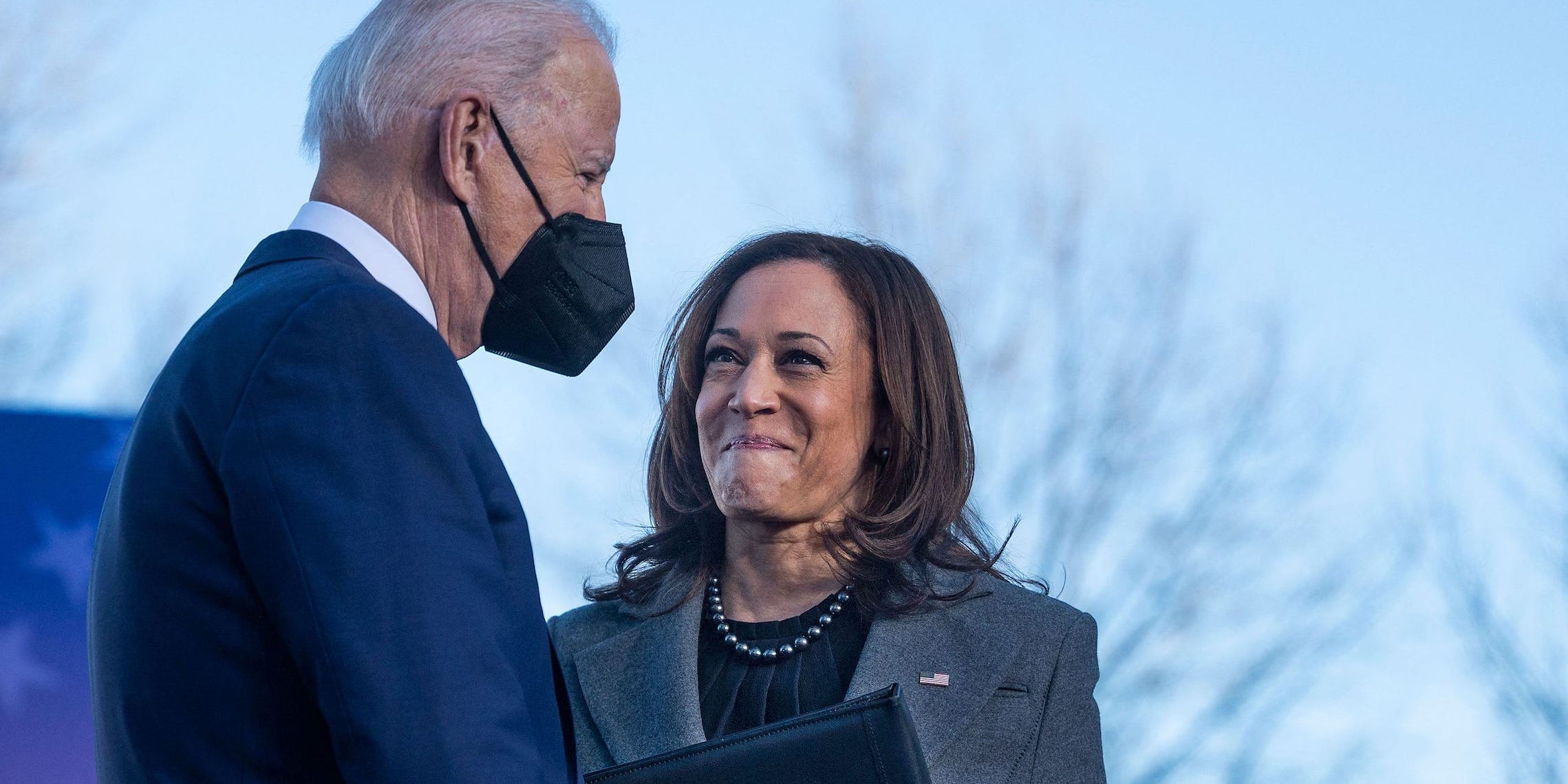 A masked Joe Biden is greeted by Kamala Harris after finishing her speech.