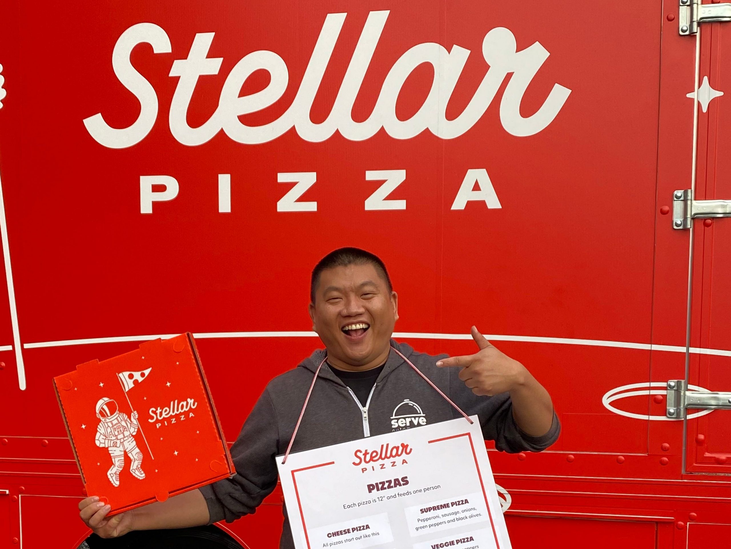 Stellar Pizza CEO Benson Tsai standing outside truck.