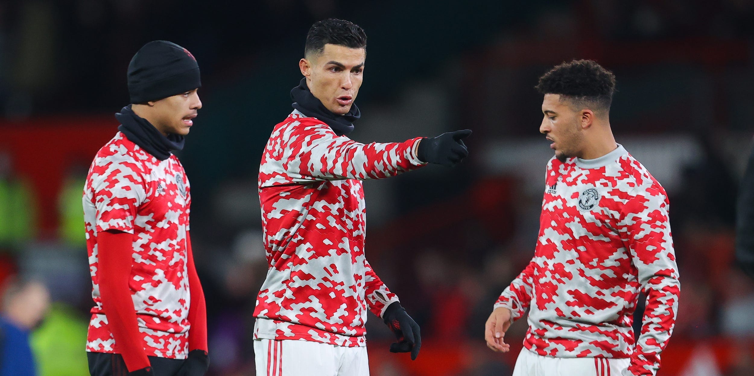 Cristiano Ronaldo gives instructions to teammates Mason Greenwood and Jadon Sancho during a pre-match warm up.