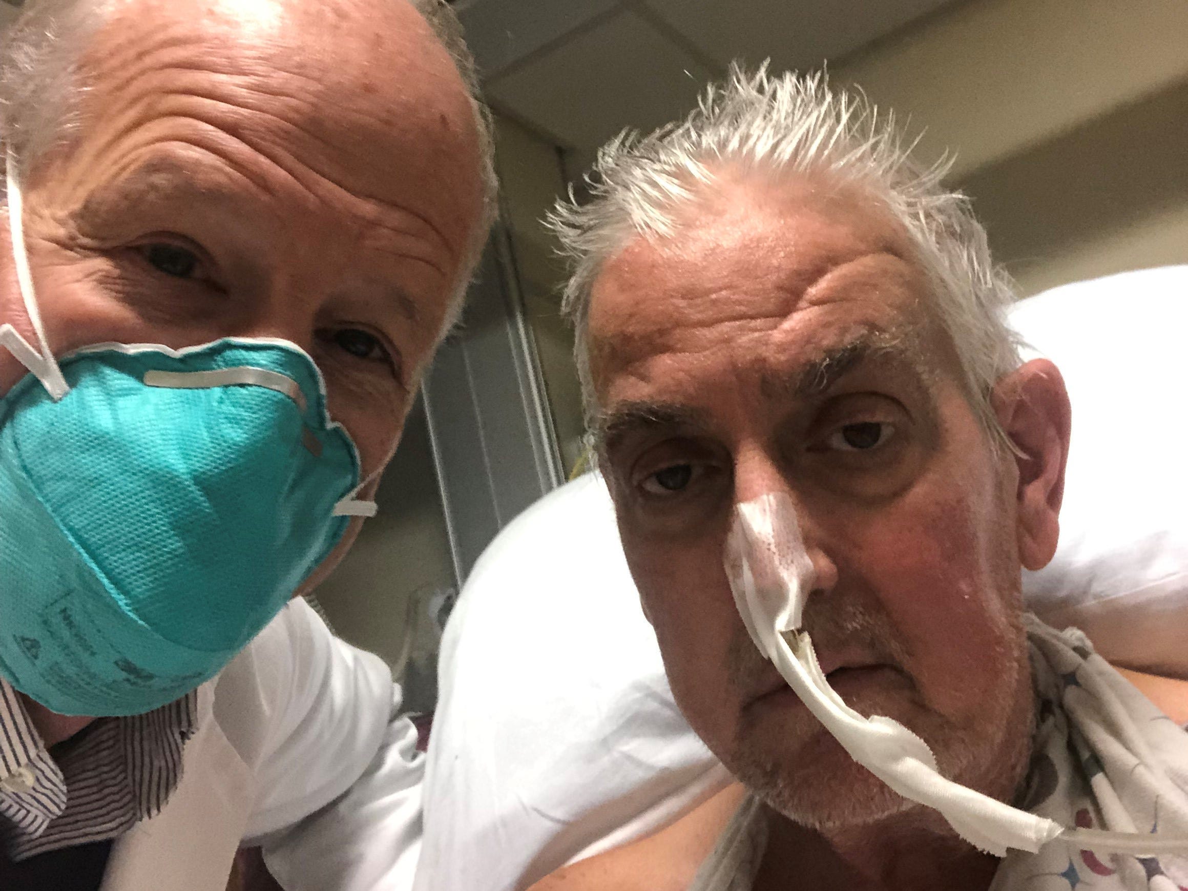 doctor in face mask selfie with patient with nose tube