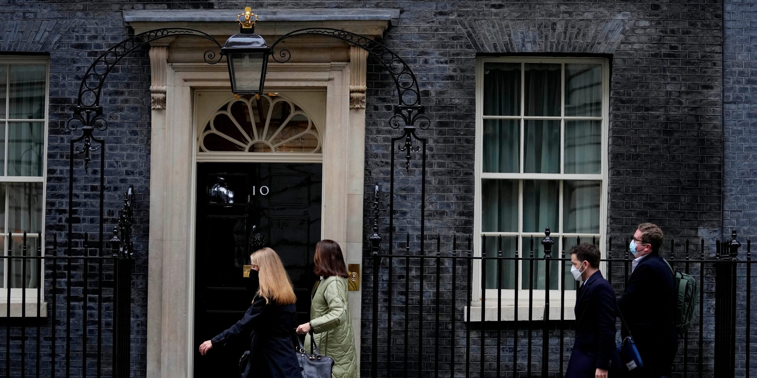 People walk in front of 10 Downing Street.