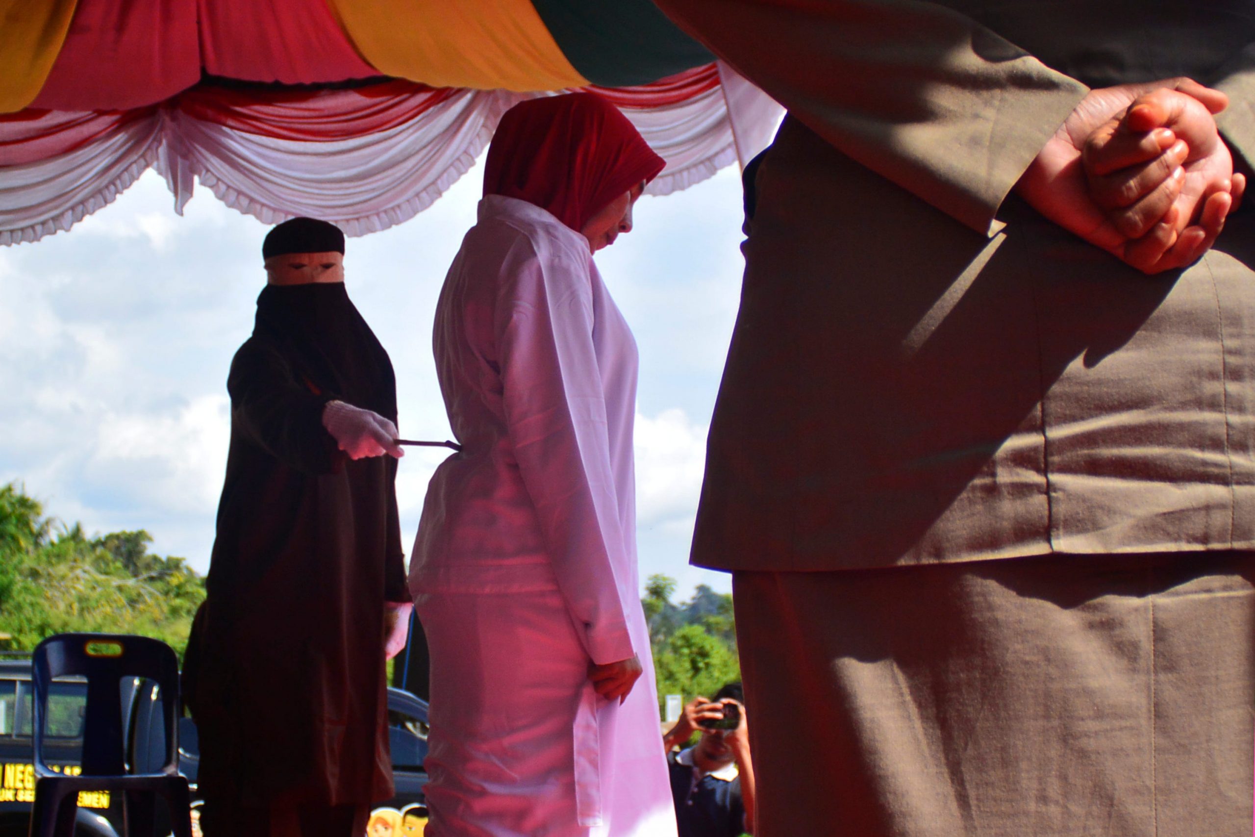 A woman flogged by a member of the Sharia police in Blangpidie.