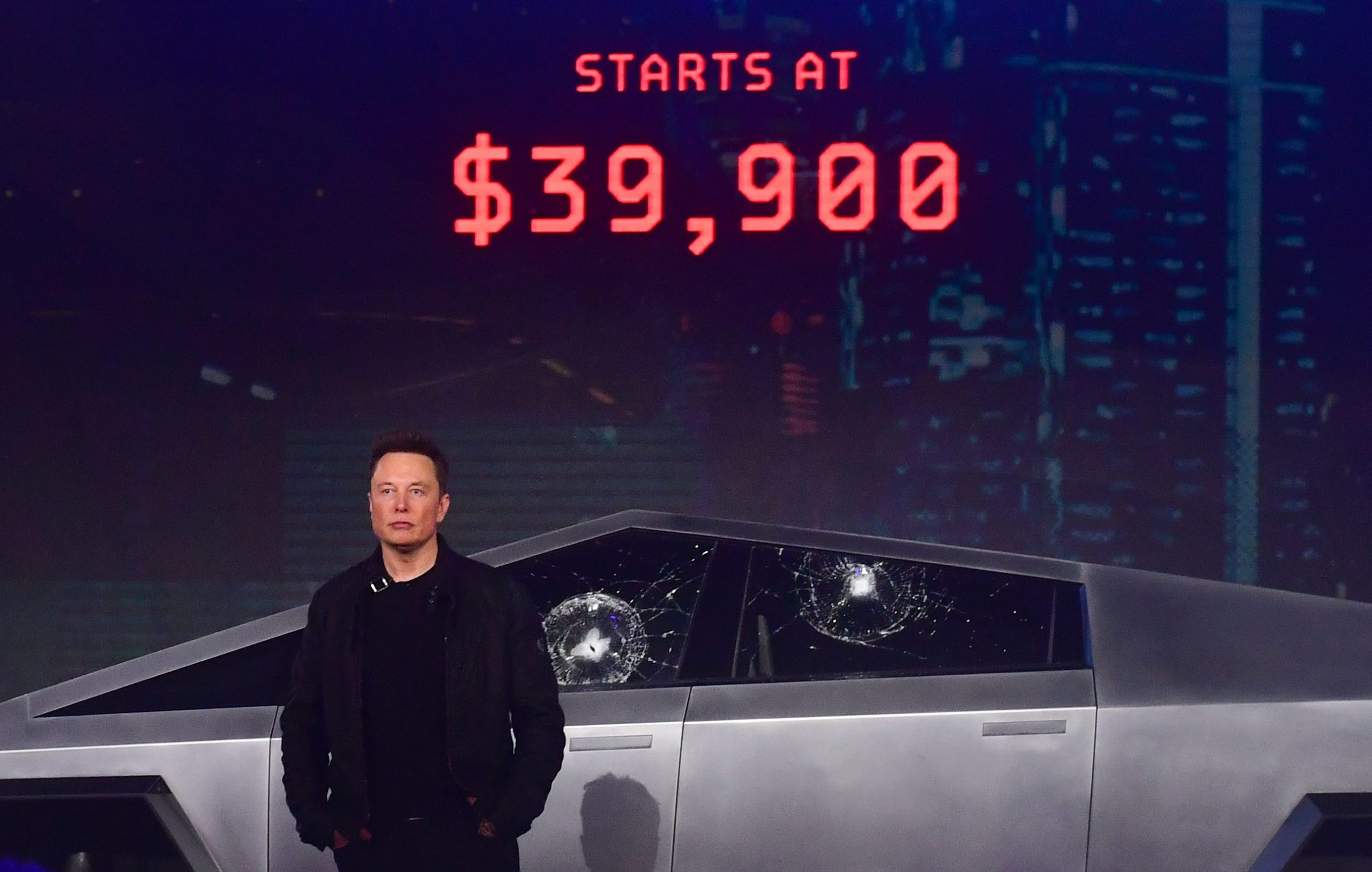 Tesla co-founder and CEO Elon Musk stands in front of the newly unveiled all-electric battery-powered Tesla's Cybertruck